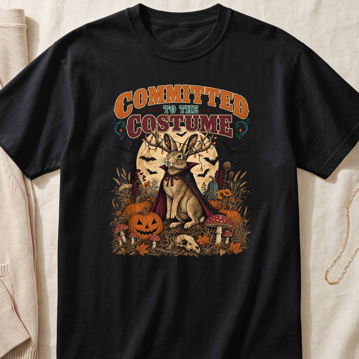 Black t-shirt with "Committed to the Costume" text and a rabbit in vampire costume.
