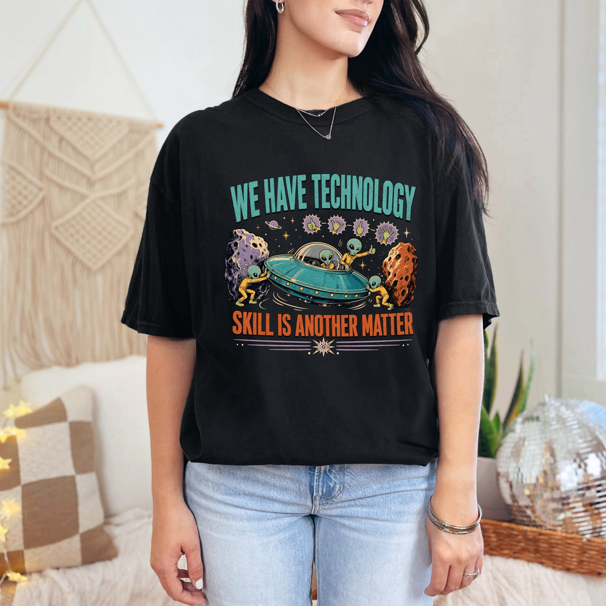 Black t-shirt with aliens in a UFO, text reads "WE HAVE TECHNOLOGY SKILL IS ANOTHER MATTER".