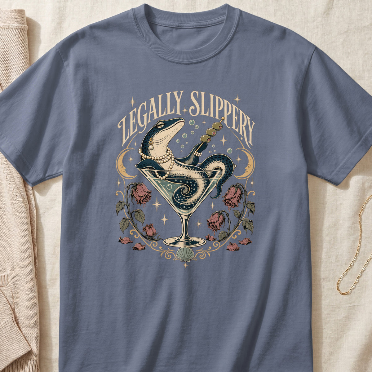 T-shirt with "Legally Slippery" text, lizard in martini glass, roses, and moons.