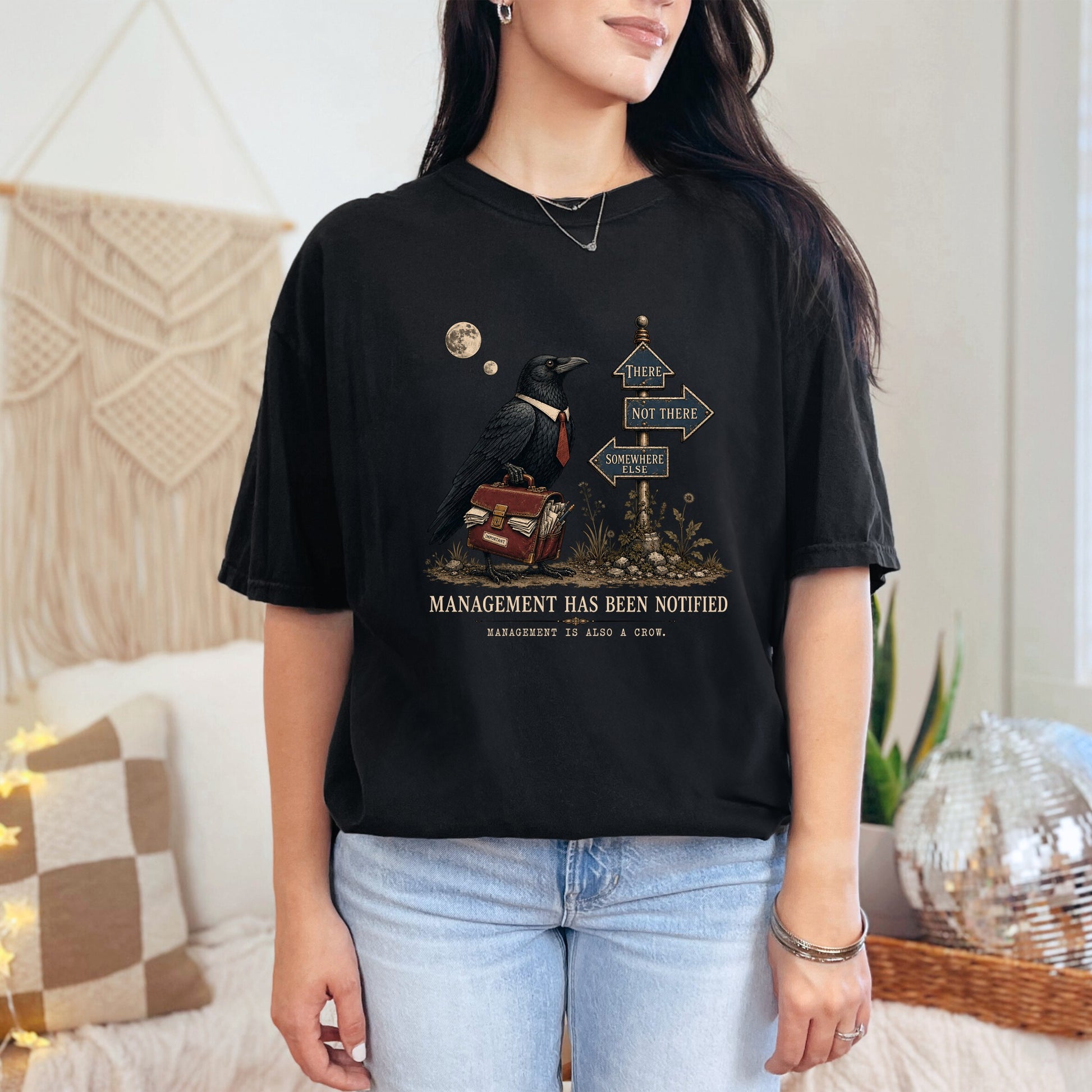 Black t-shirt with crow graphic, briefcase, and directional signs.