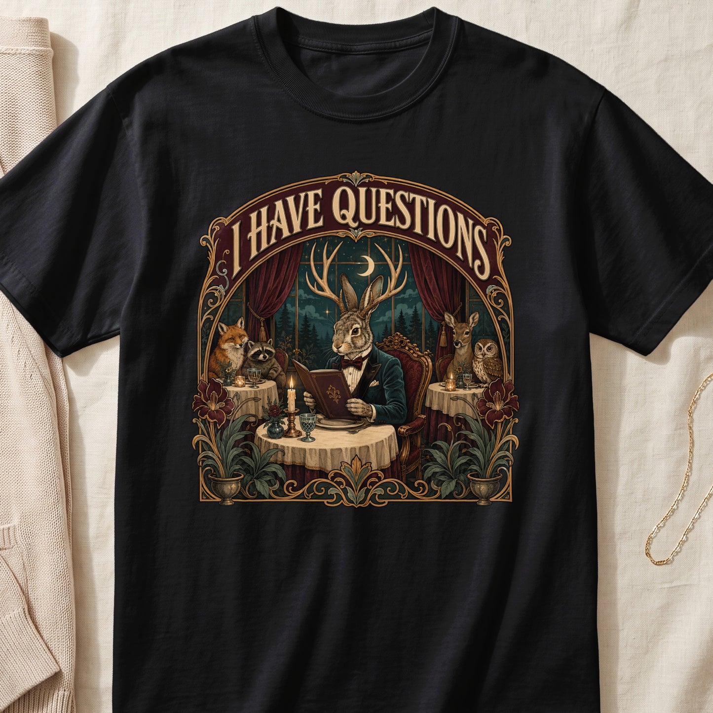 T-shirt graphic with text "I HAVE QUESTIONS" featuring anthropomorphic animals at a dinner table.