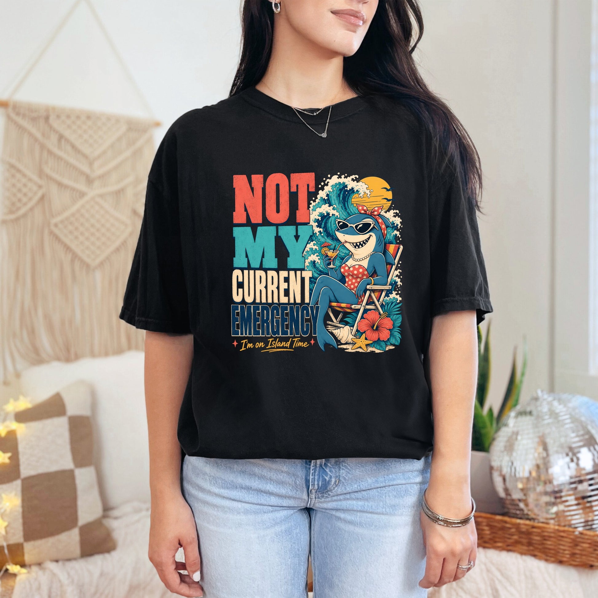 Black t-shirt with "NOT MY CURRENT EMERGENCY" and a shark relaxing on island time.