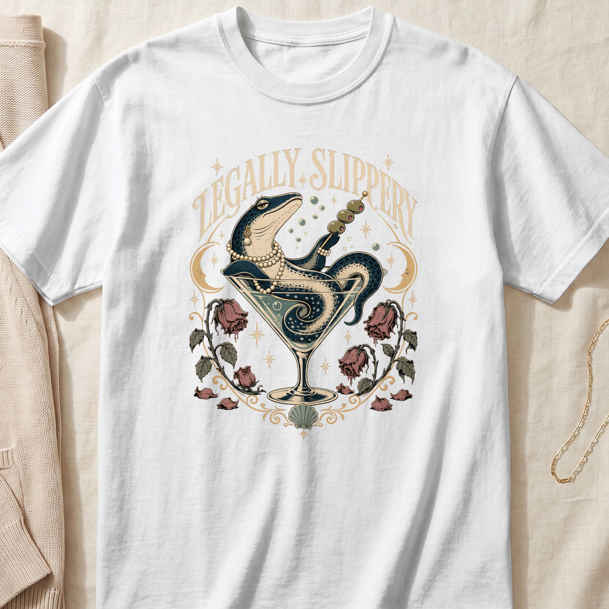Lizard in a martini glass with olives, text "LEGALLY SLIPPERY", moons, and roses.