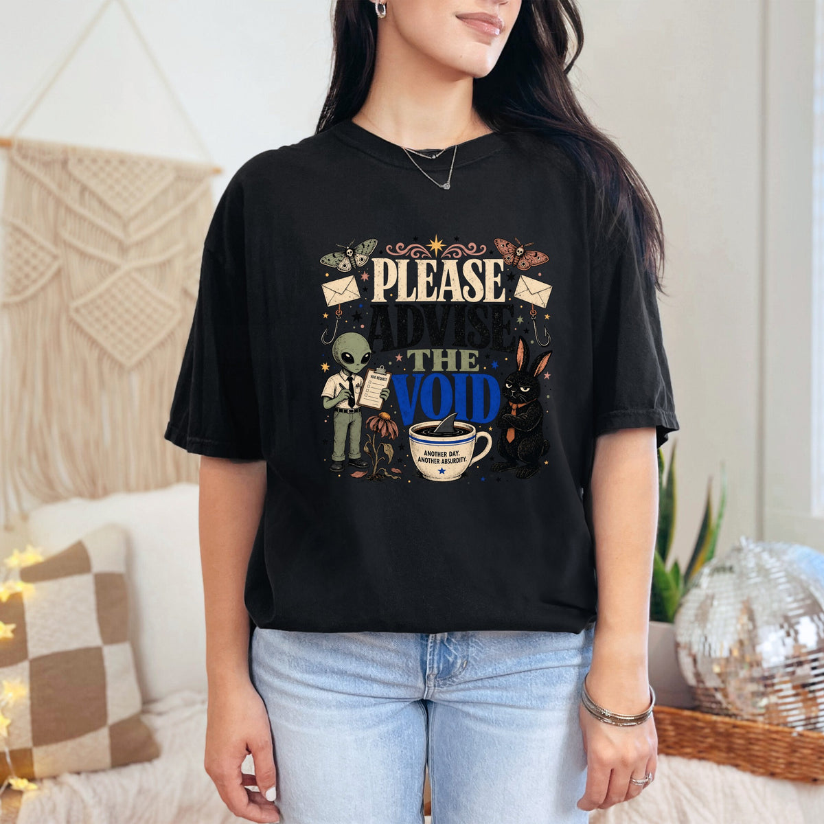 Black t-shirt graphic with alien and rabbit next to "Please Advise the Void".
