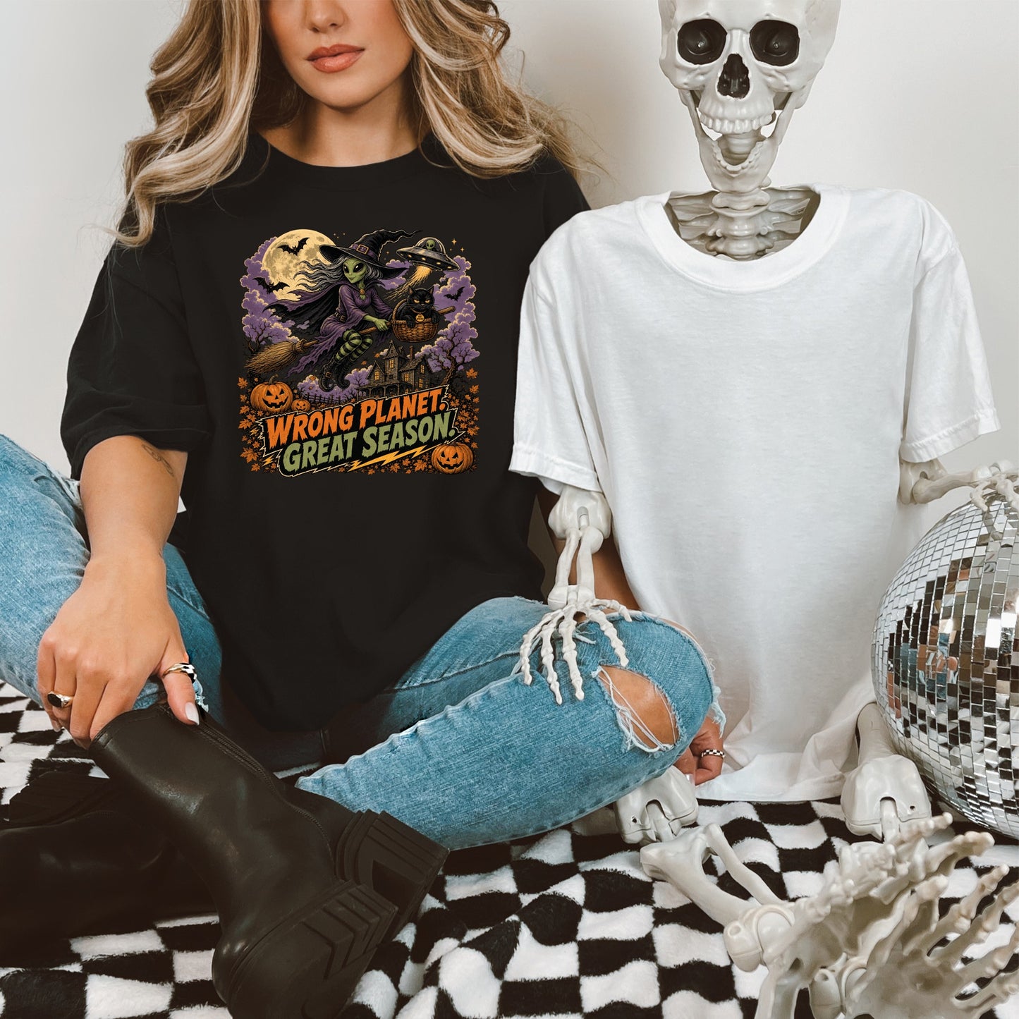 Black t-shirt with alien witch graphic and text "Wrong Planet, Great Season".