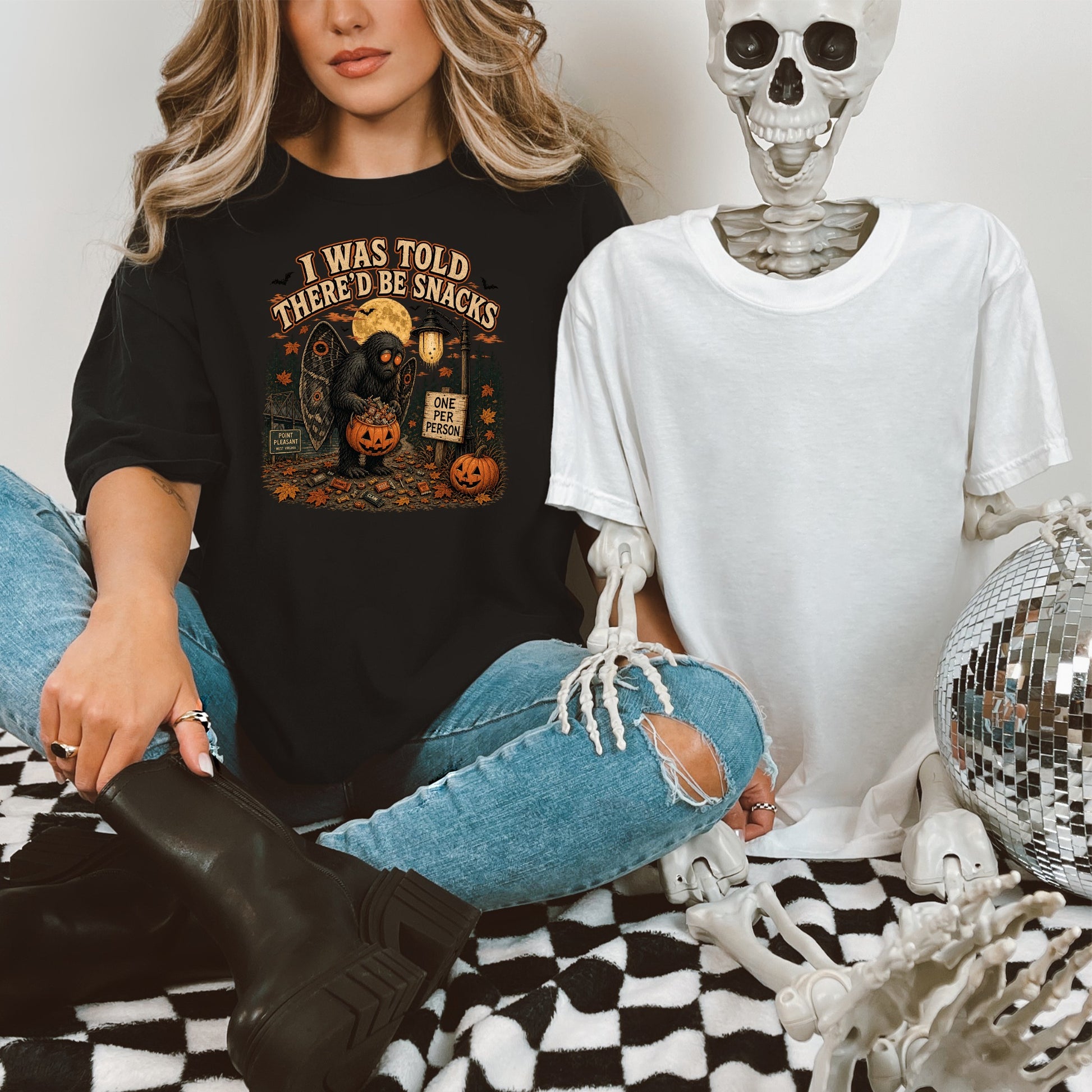 Black t-shirt with Mothman holding a candy pumpkin, "I was told there'd be snacks" text.