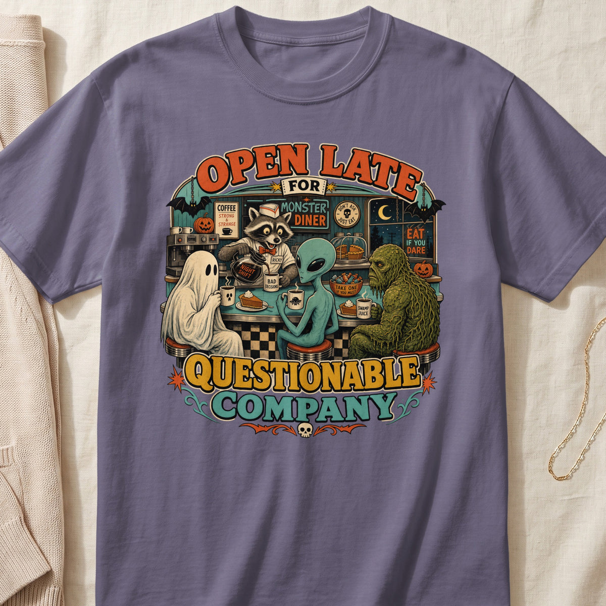 Shirt graphic featuring a ghost, alien, and swamp monster at a diner.