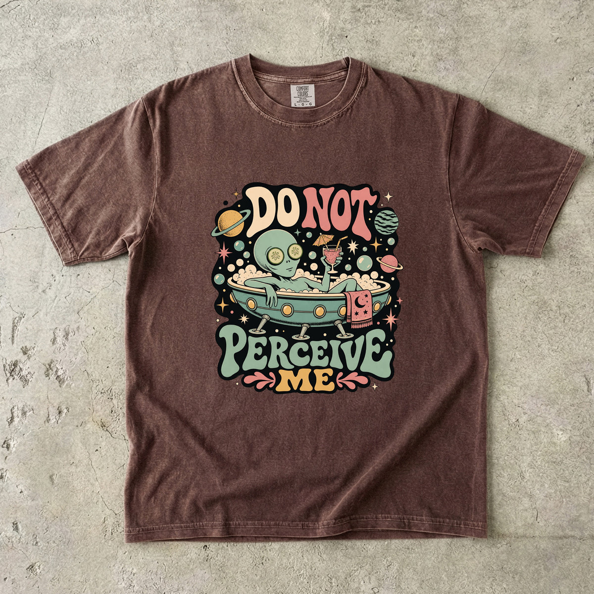 Brown t-shirt with alien relaxing in a bathtub graphic and "DO NOT PERCEIVE ME" text.