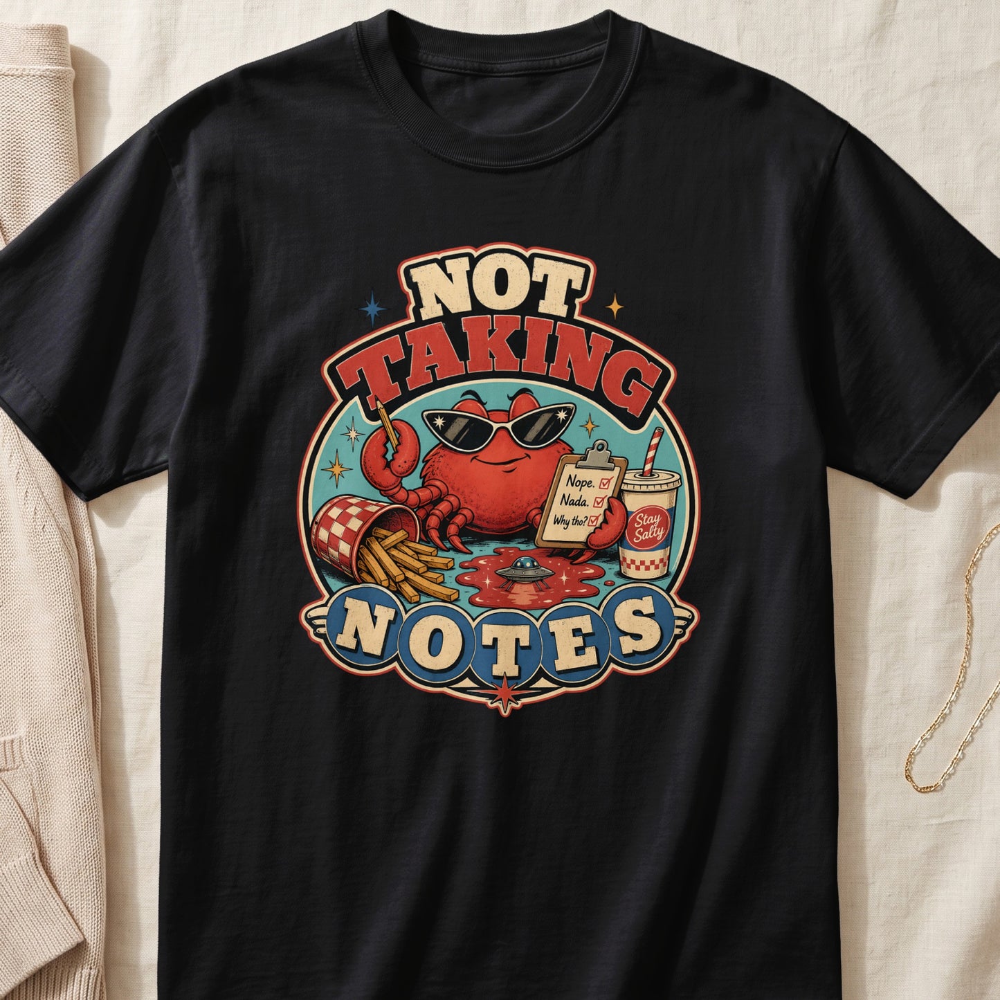 Black t-shirt graphic with crab saying "NOT TAKING NOTES".