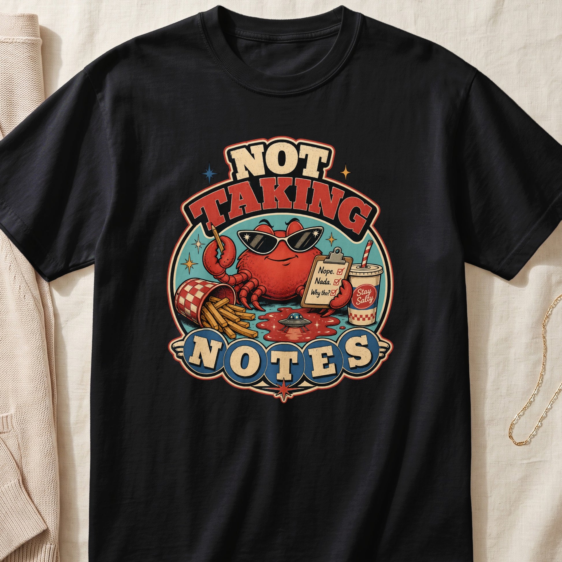 Black t-shirt graphic with crab saying "NOT TAKING NOTES".