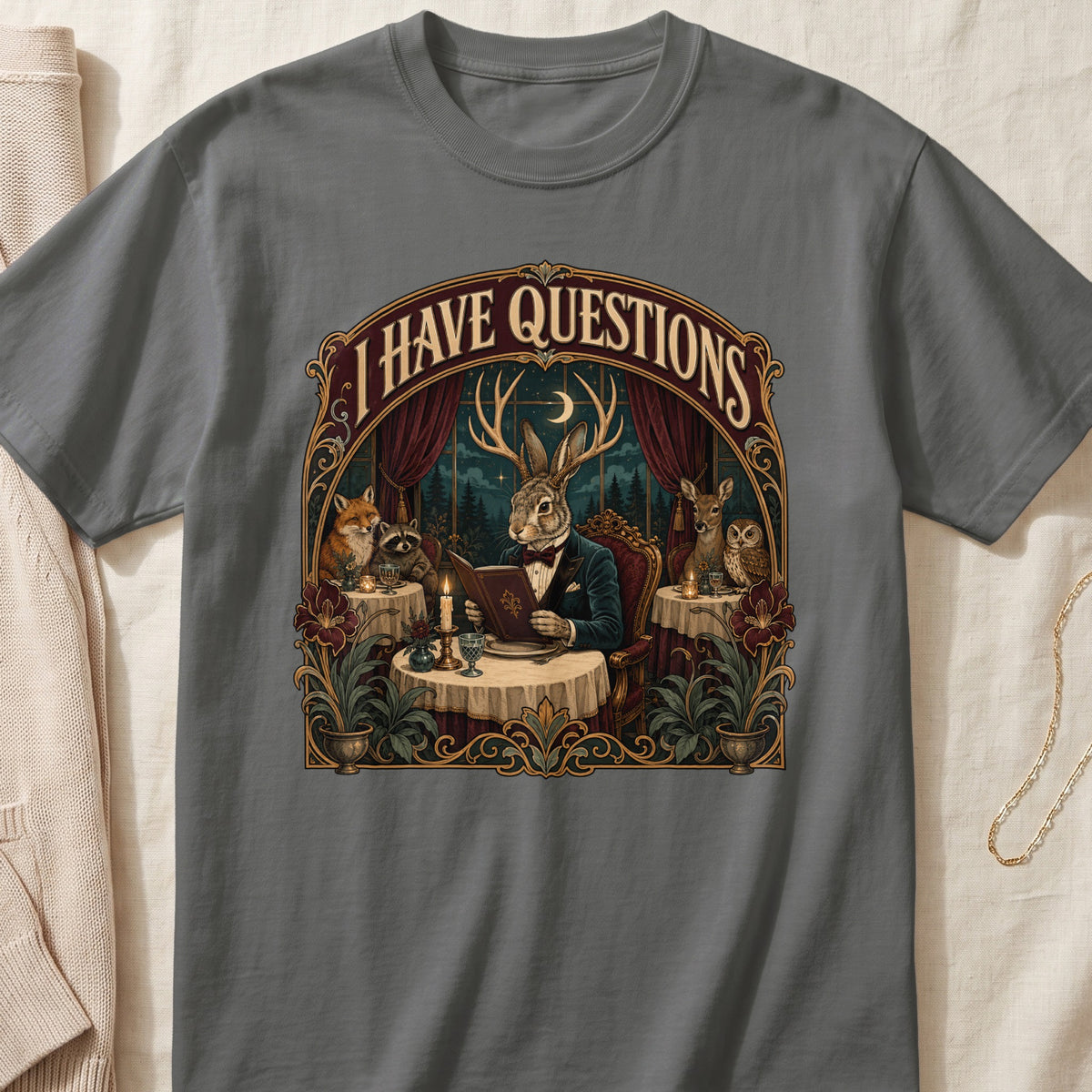 T-shirt graphic with anthropomorphic animals reading a book under the moon.
