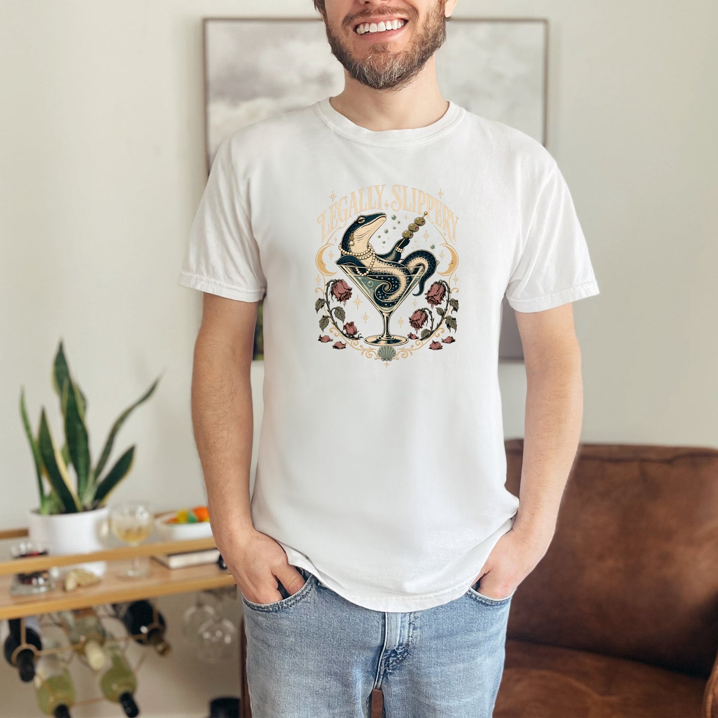 White t-shirt with a graphic of a snake in a martini glass with text "Legally Slippery".