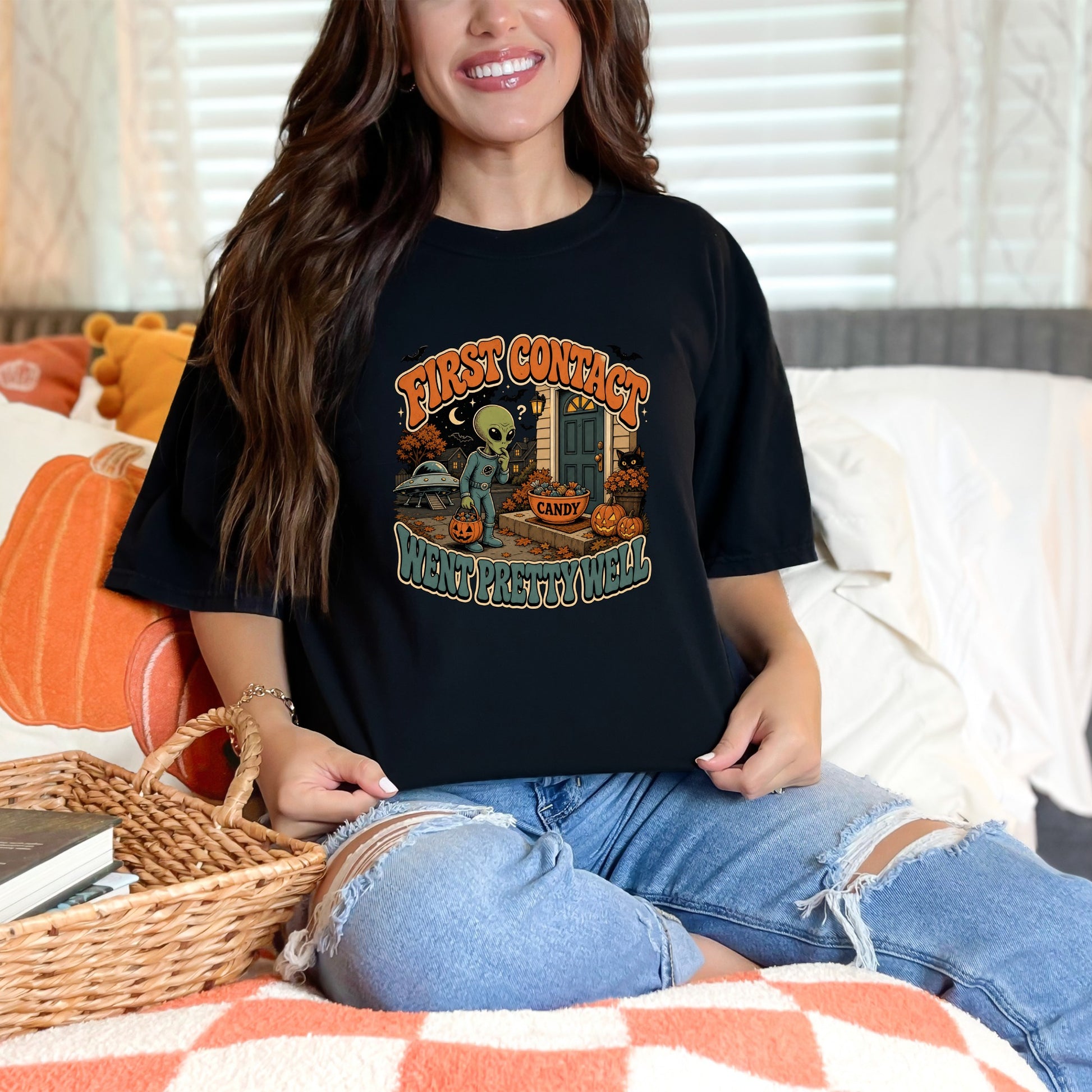 Black t-shirt with "First Contact Went Pretty Well" Halloween alien graphic.