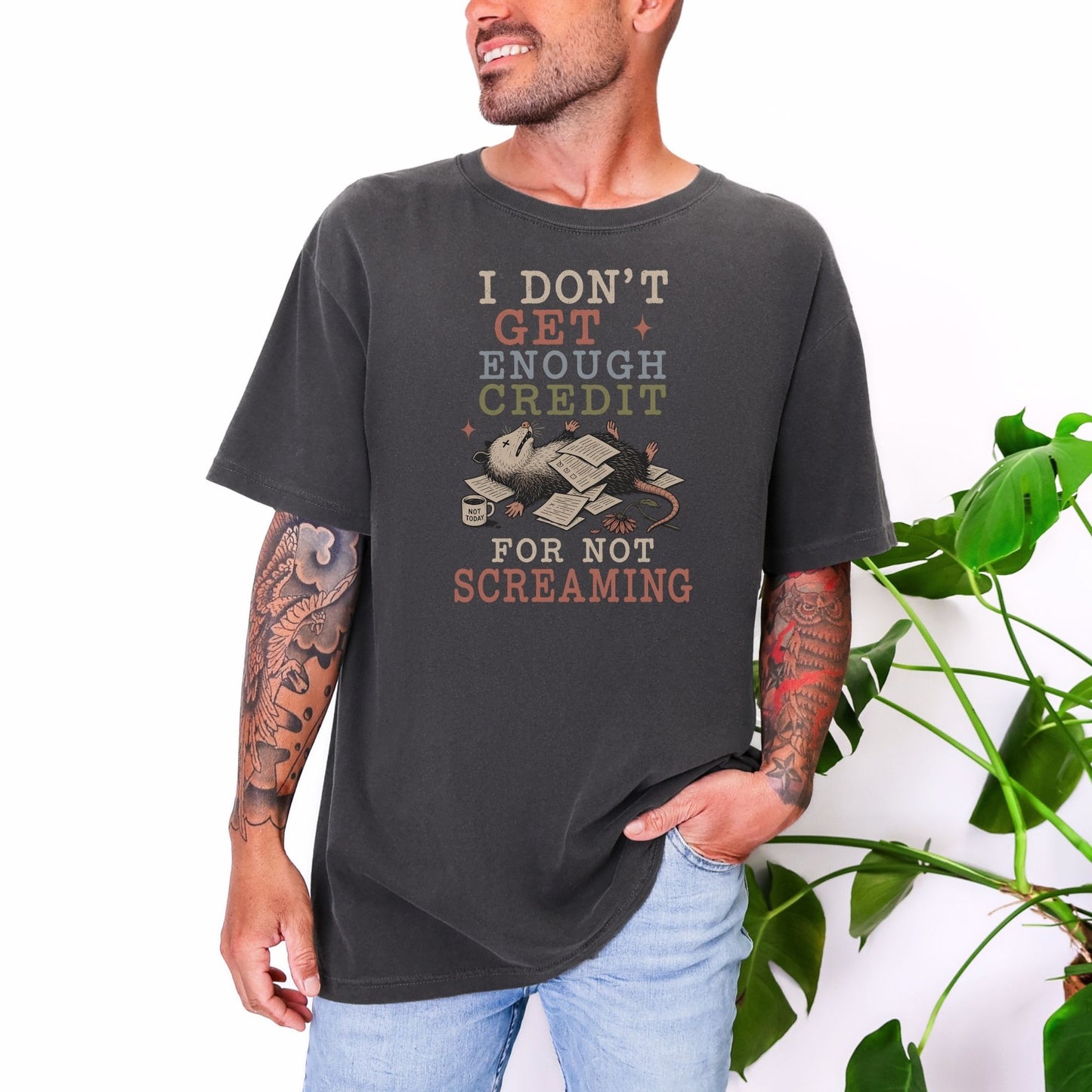Dark grey t-shirt with text "I don't get enough credit for not screaming" and a possum.