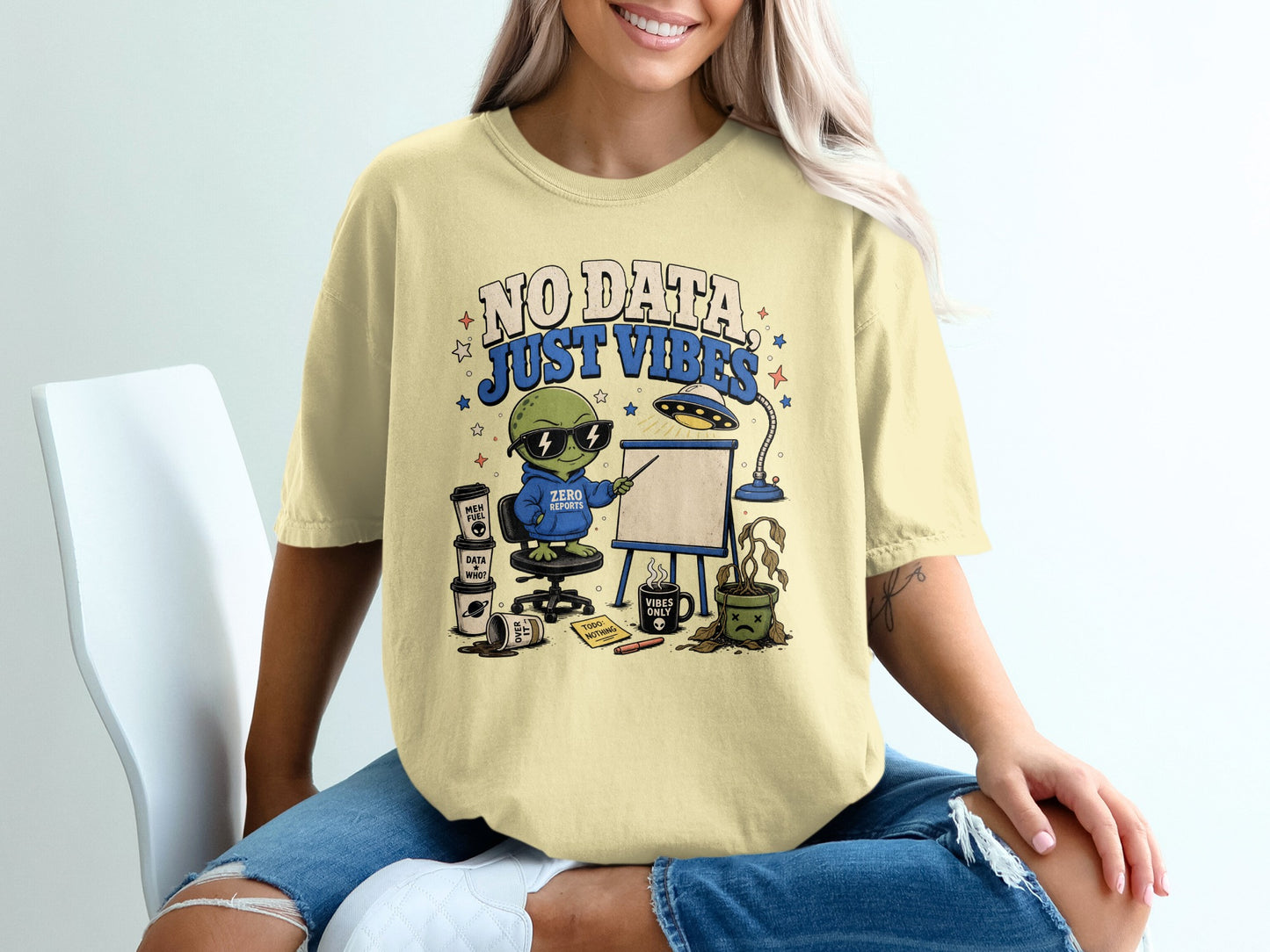 Yellow t-shirt with "NO DATA JUST VIBES" text and cartoon alien.