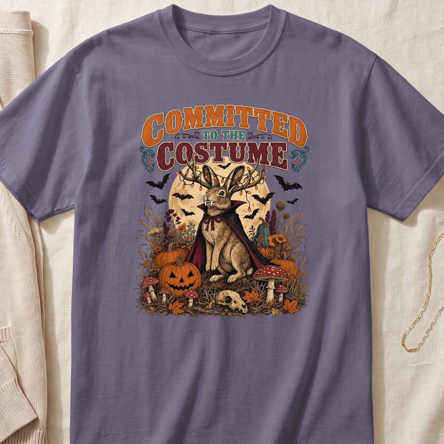 T-shirt graphic: rabbit in vampire costume, text "Committed to the Costume", Halloween scene.