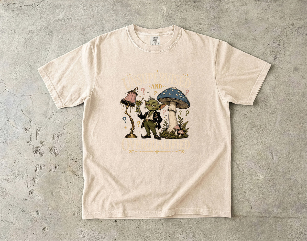 T-shirt with a goblin holding a martini and text reading "Supervised and Overqualified".