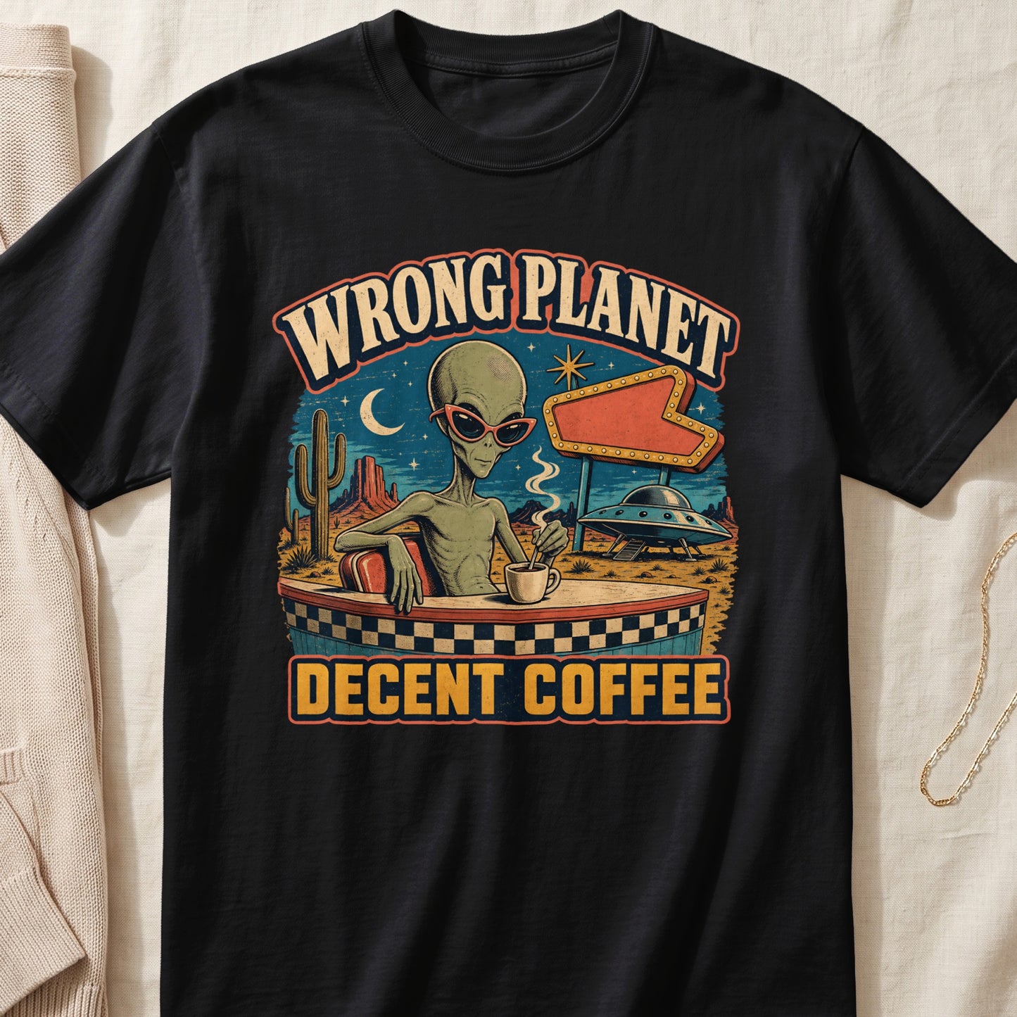 Alien wearing sunglasses at a diner with text "Wrong Planet Decent Coffee".