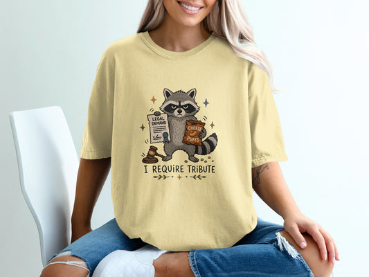 Raccoon holding legal demand and cheese puffs, text "I REQUIRE TRIBUTE."