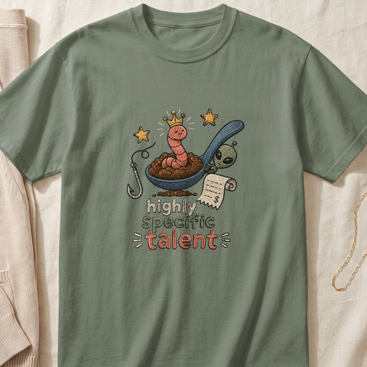 Worm with crown and alien on a spoon, holding a bill, with text "highly specific talent".