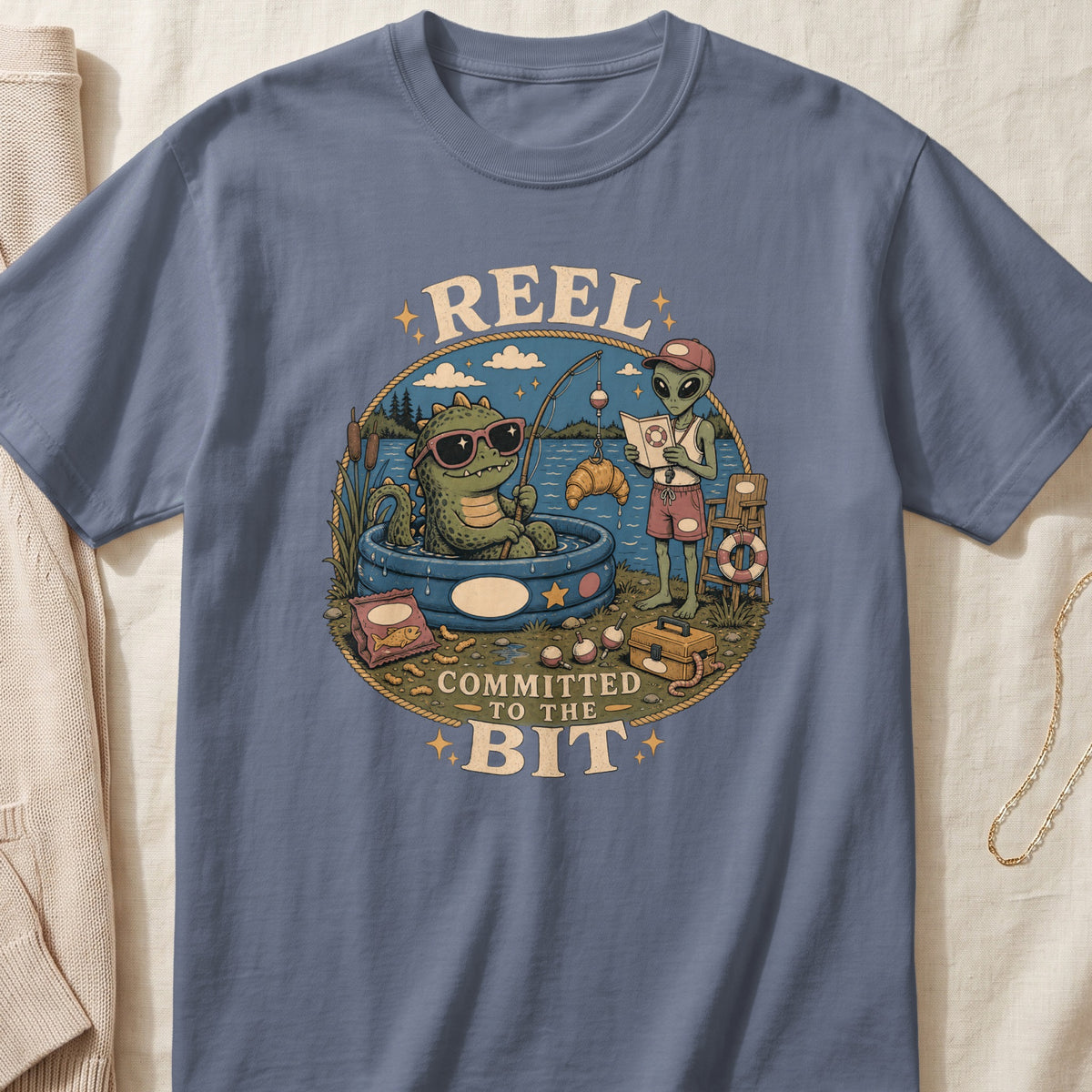 Dinosaur and alien fishing with text "REEL COMMITTED TO THE BIT".