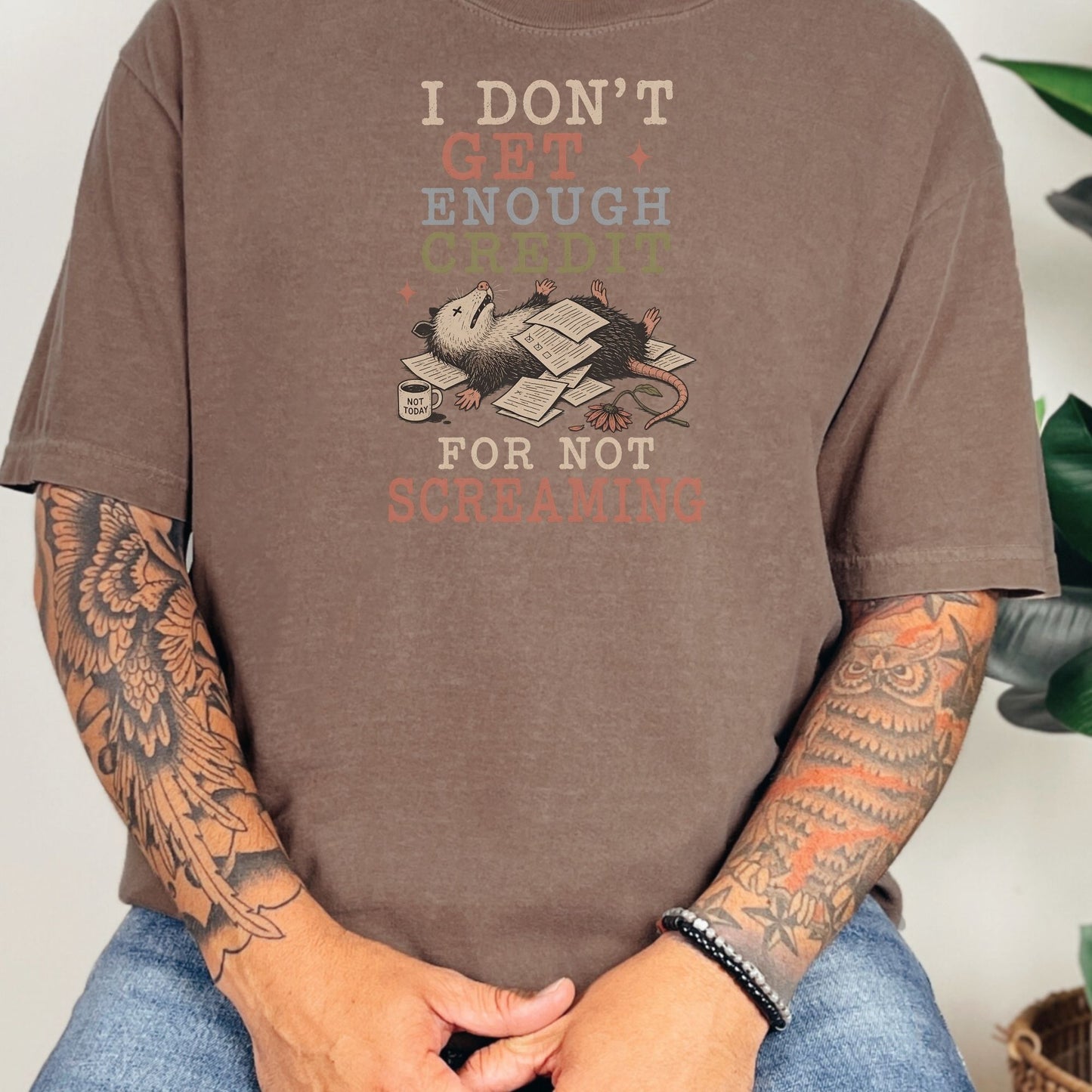 T-shirt graphic with possum on papers saying "I don't get enough credit for not screaming."