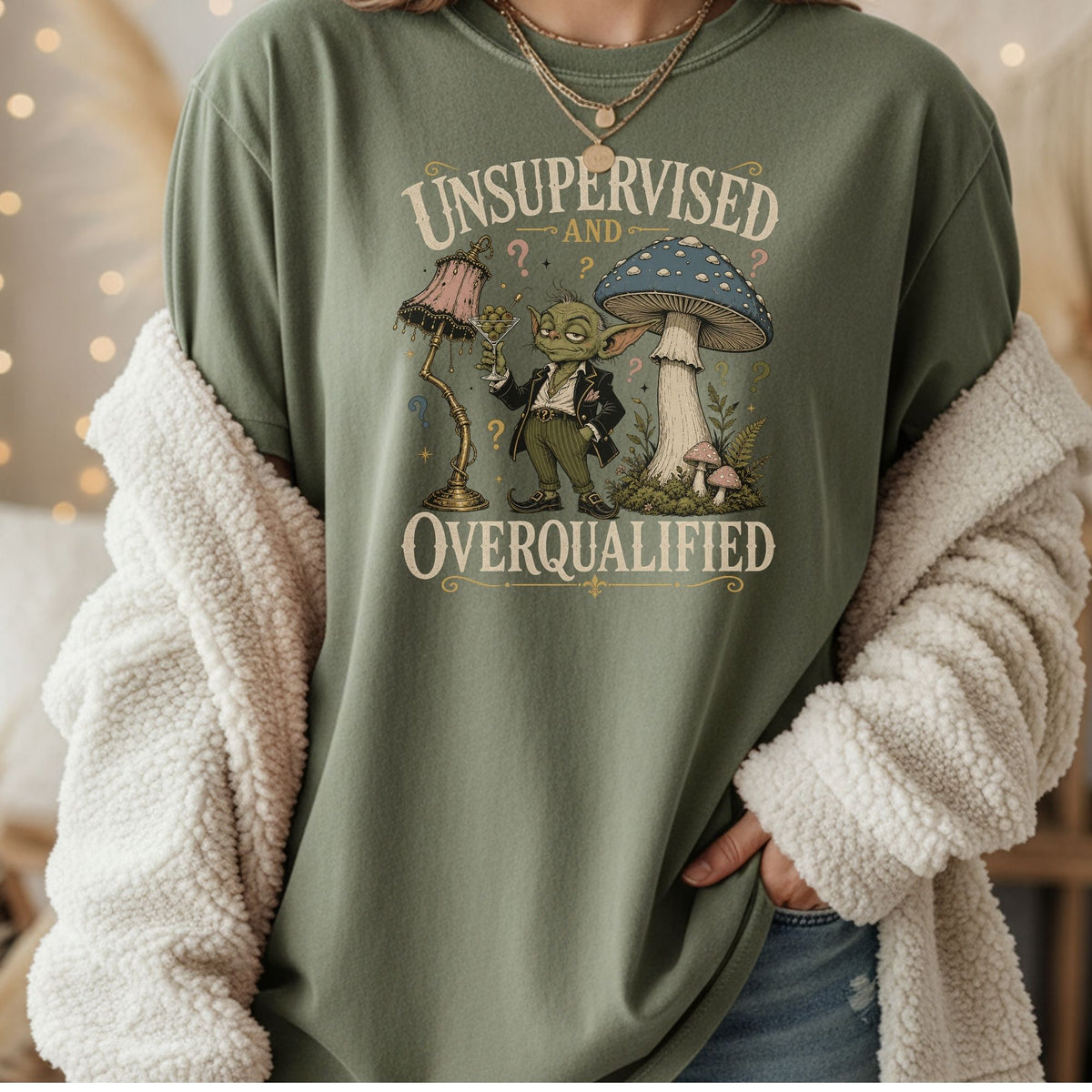 Green t-shirt with "Unsupervised and Overqualified" text and a cartoon character with a mushroom.