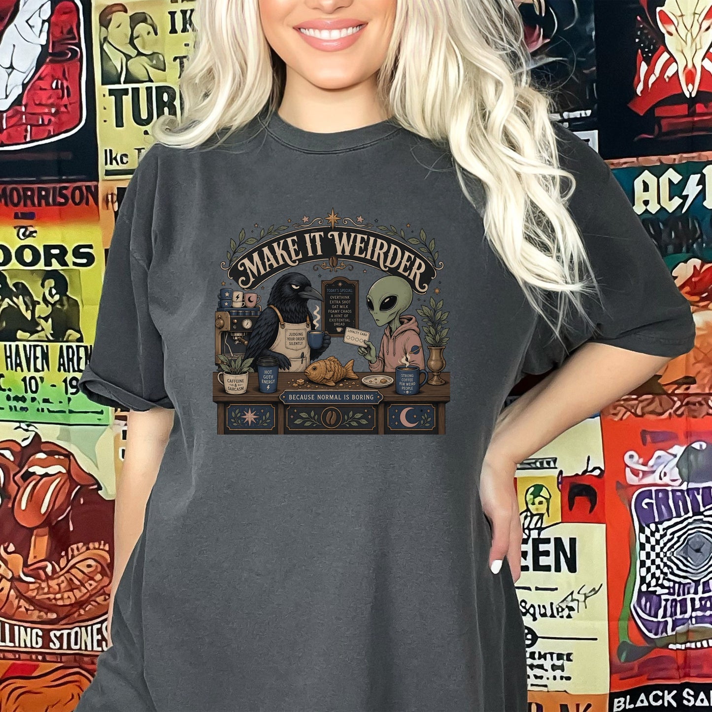 T-shirt graphic: raven and alien at coffee counter with text "Make it Weirder".