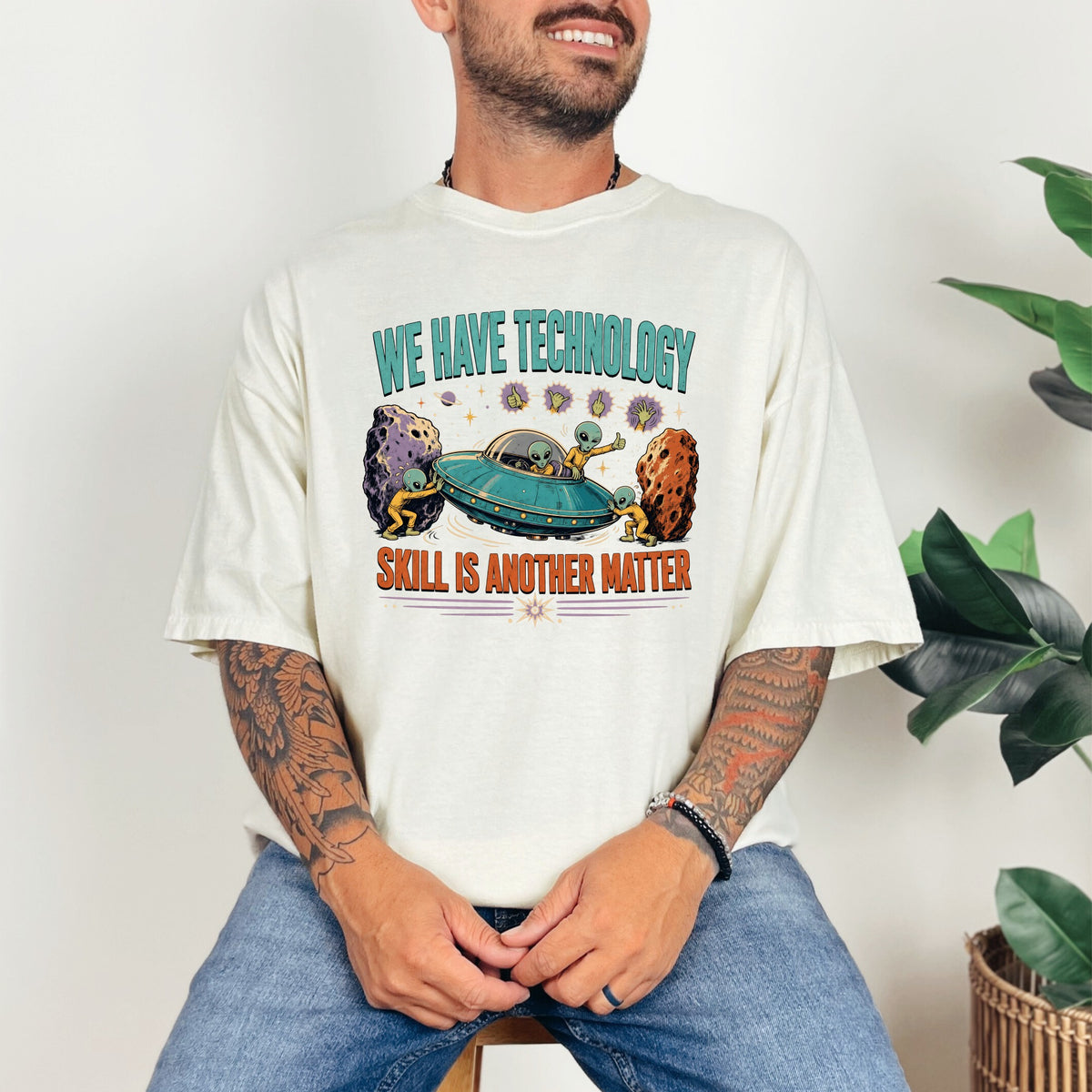 Shirt graphic with text "WE HAVE TECHNOLOGY SKILL IS ANOTHER MATTER" and aliens with a UFO.