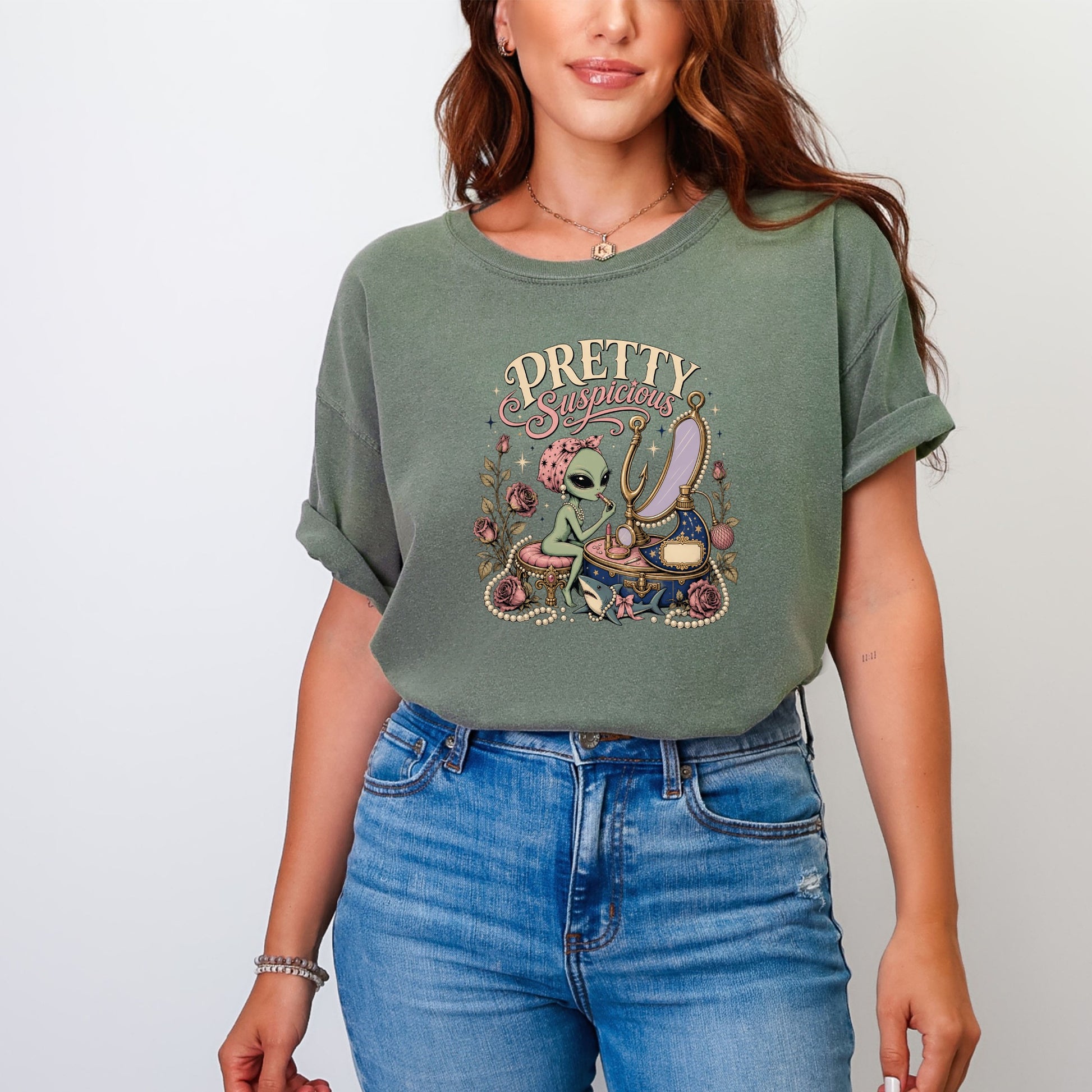 Alien applying makeup with "PRETTY Suspicious" text above and decorative roses.