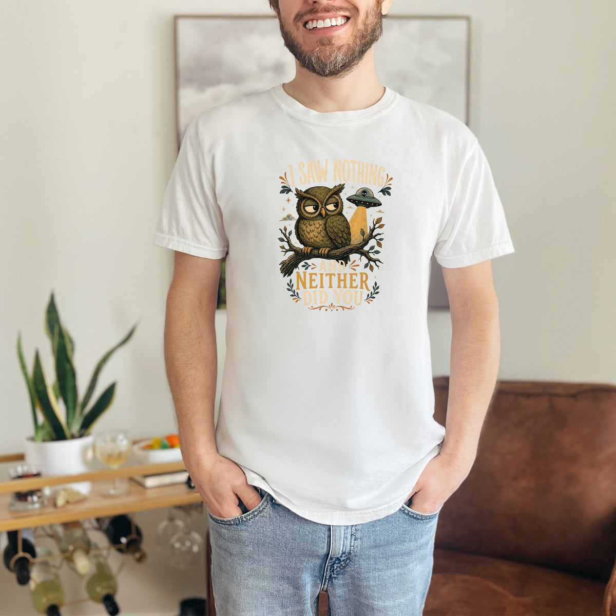 White t-shirt with an owl, UFO, and text reading "I saw nothing and neither did you."