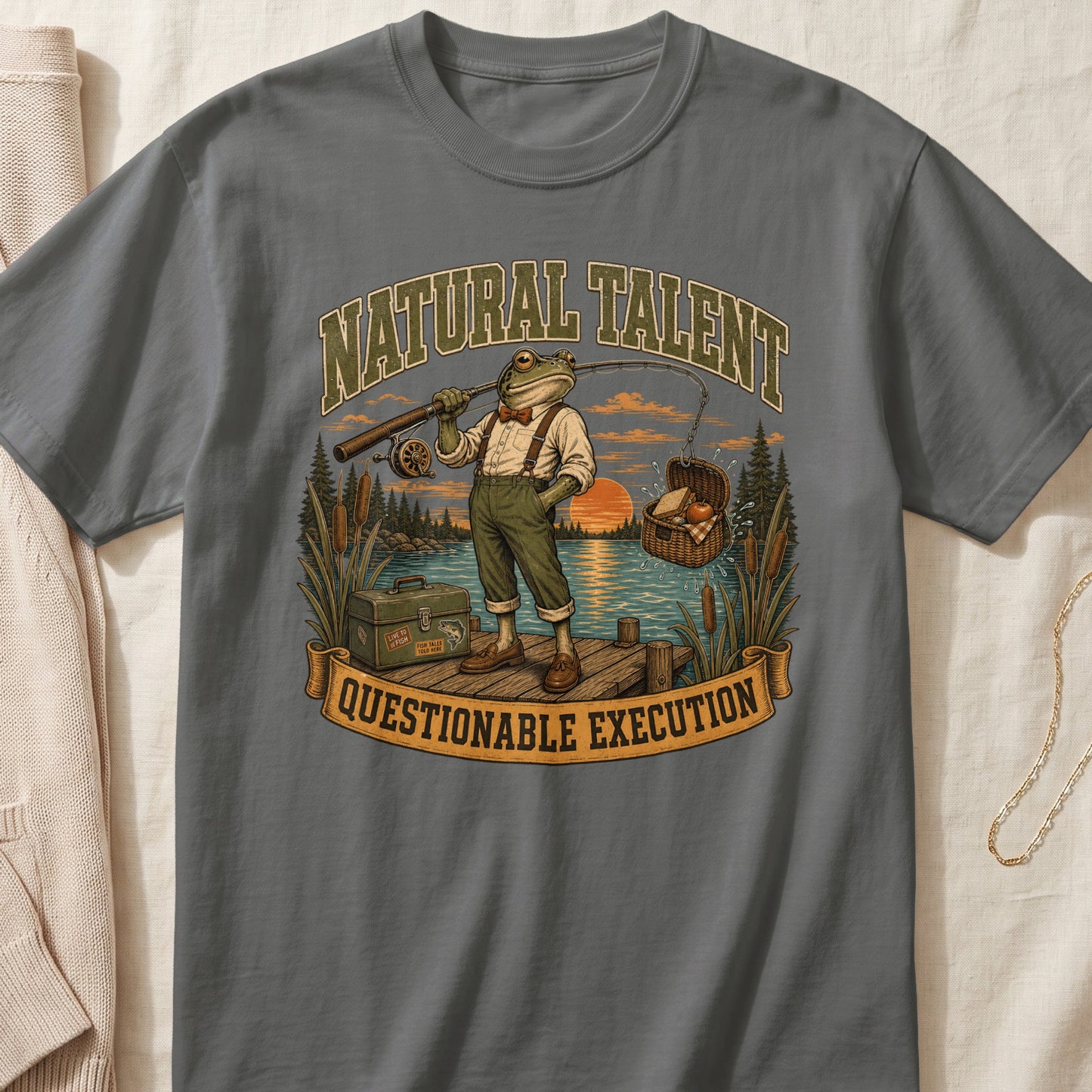 Frog fishing with text "NATURAL TALENT QUESTIONABLE EXECUTION" on a t-shirt.