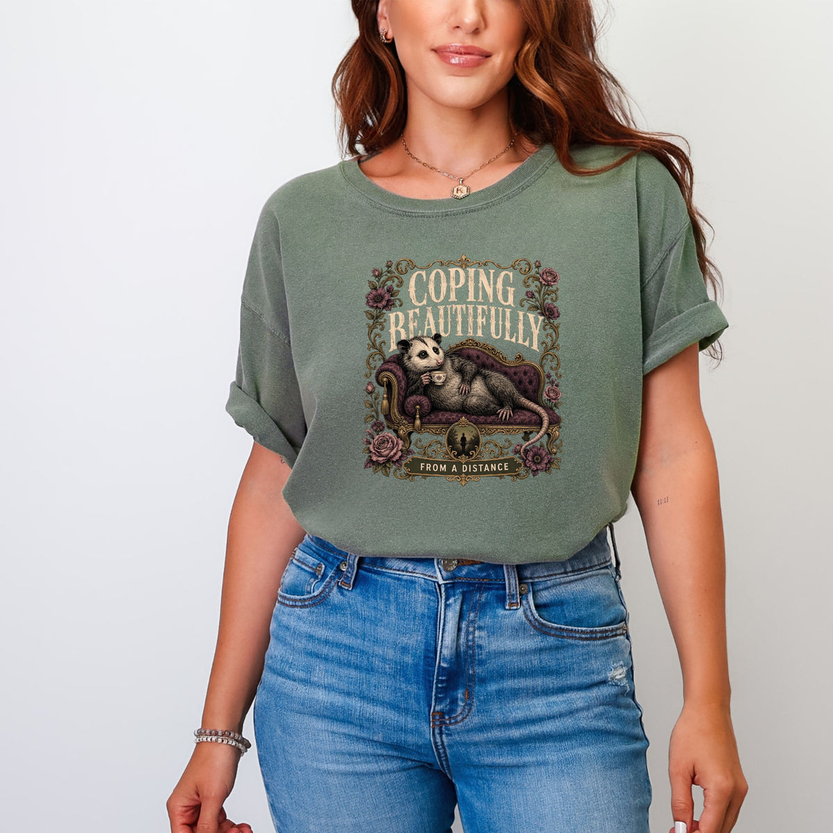 Opossum on couch with tea, text "Coping Beautifully From A Distance".