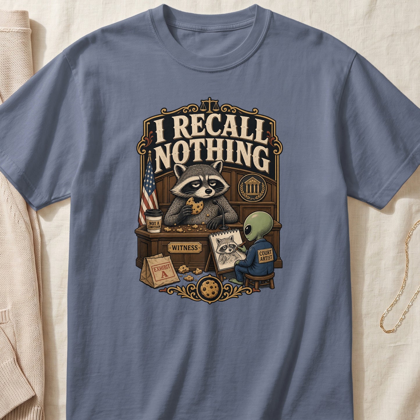 T-shirt graphic of a raccoon witness eating cookies and an alien court artist.