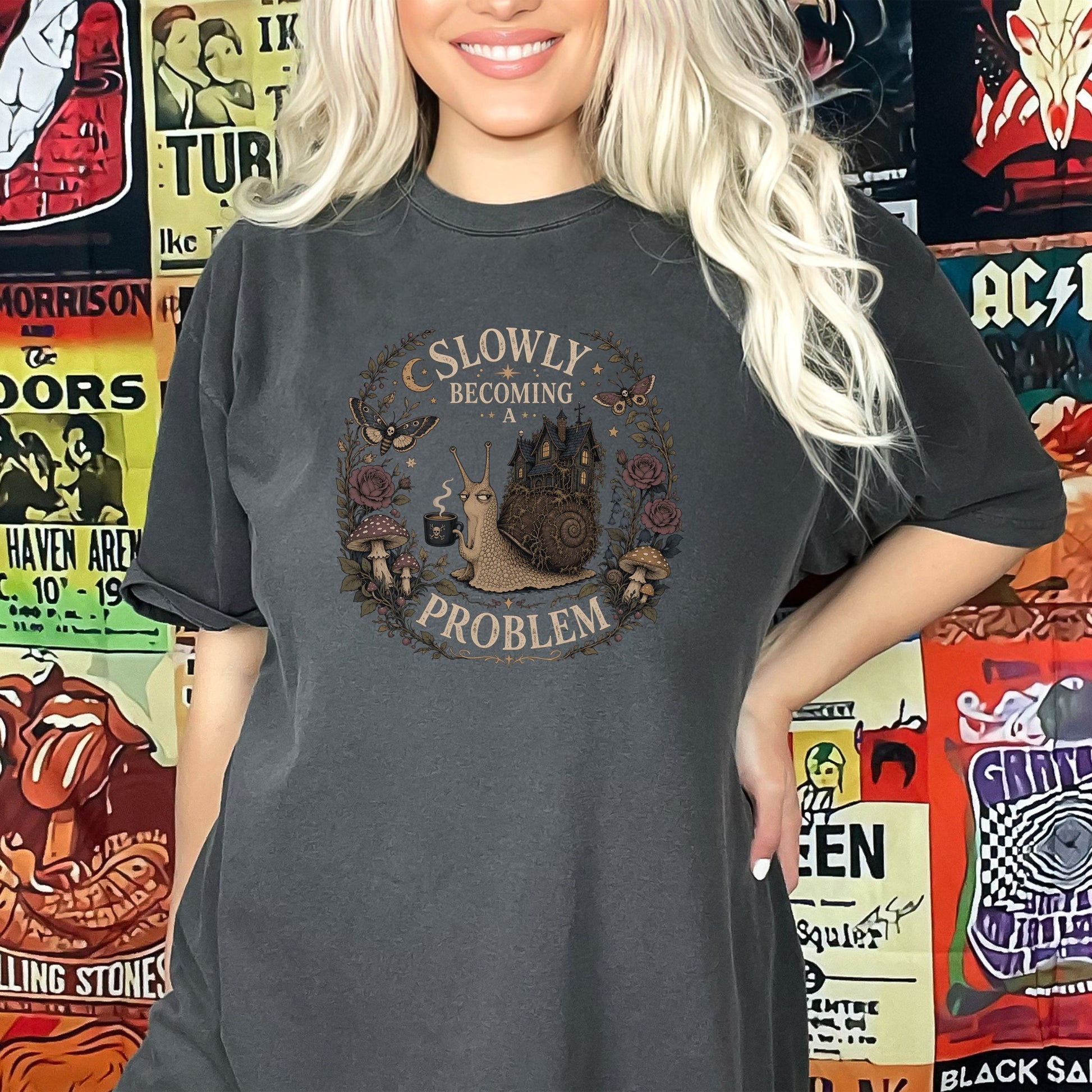 Dark grey t-shirt with graphic of a snail carrying a house and text "Slowly Becoming a Problem".