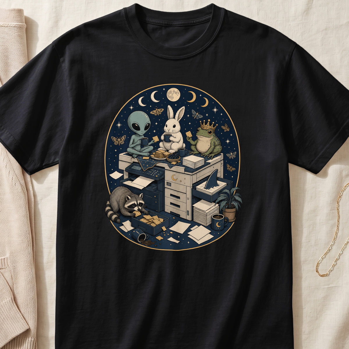 Black t-shirt featuring an illustration of an alien, rabbit, frog, and raccoon gathered around an office copier at night.
