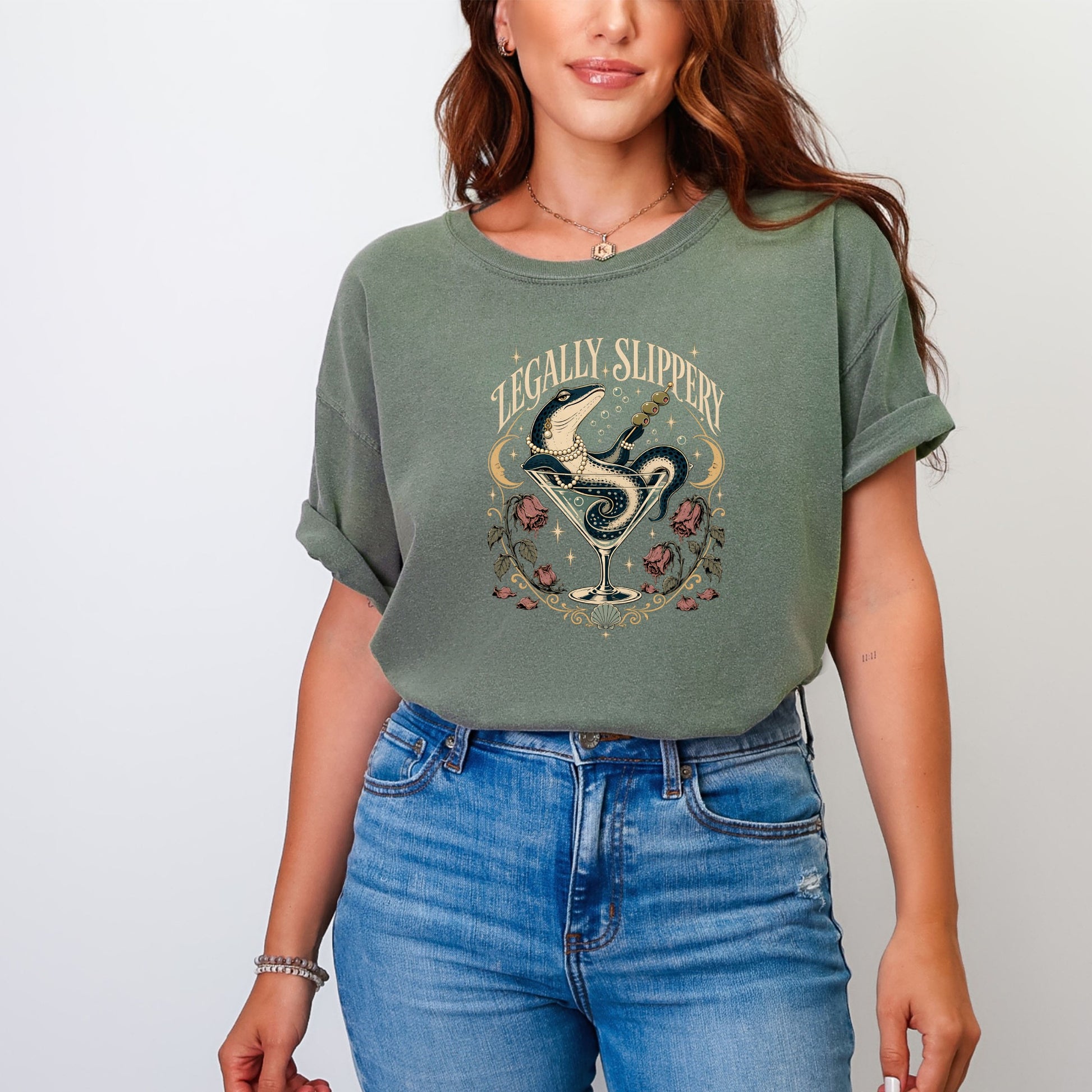 T-shirt graphic with a snake in a martini glass, text "LEGALLY SLIPPERY".