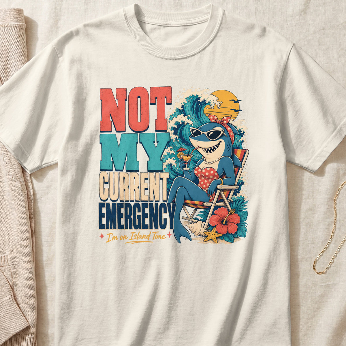 T-shirt with cartoon shark relaxing on beach chair, text "NOT MY CURRENT EMERGENCY".
