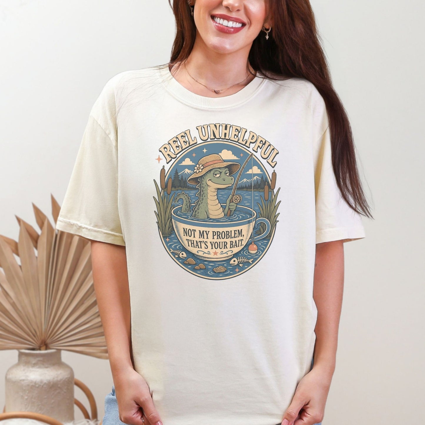 Alligator fishing in a teacup with text "Reel Unhelpful Not My Problem, That's Your Bait."