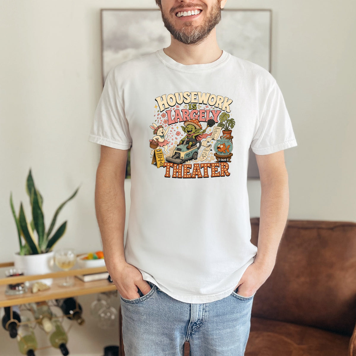 White t-shirt with cartoon illustration and text "Housework is largely theater".