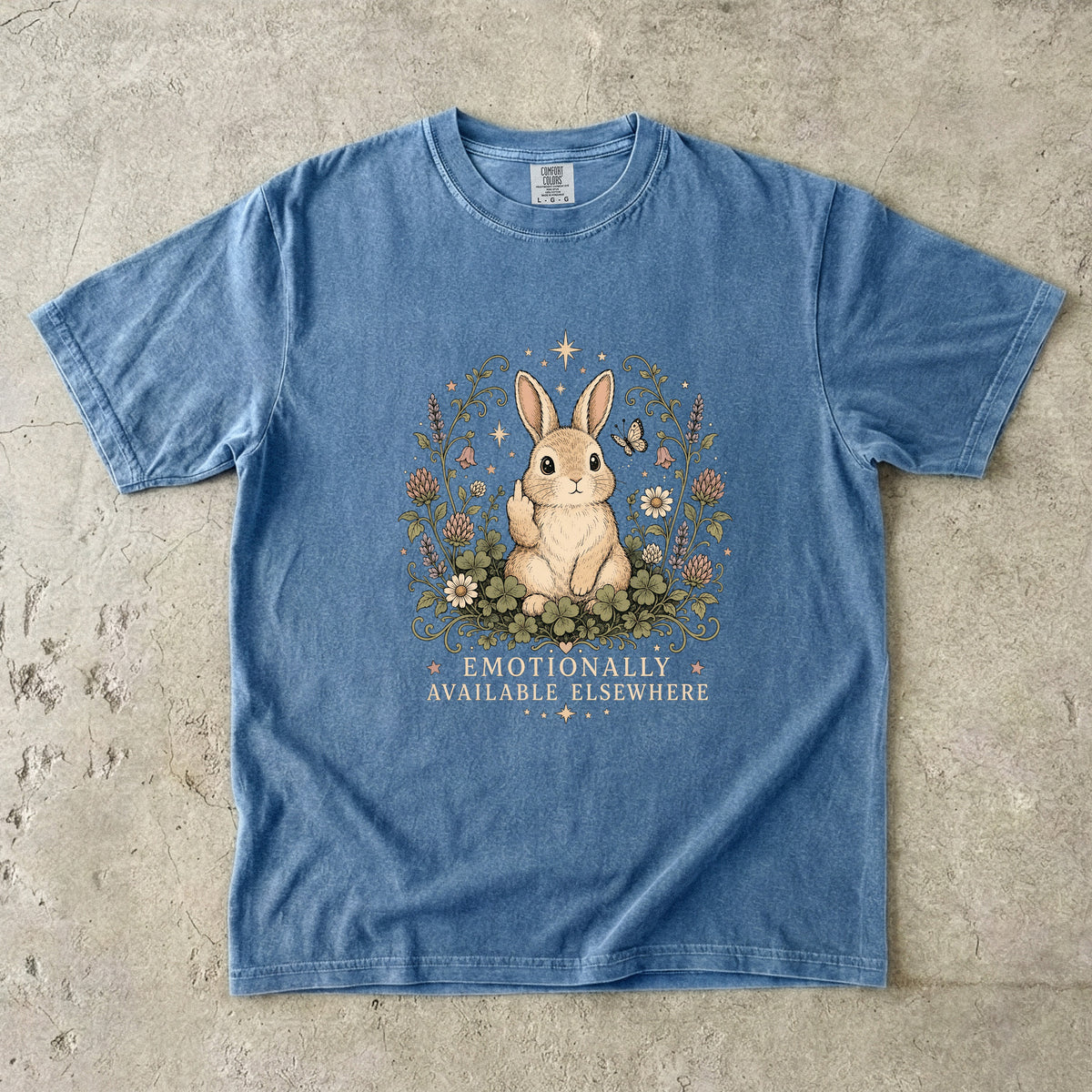 Blue t-shirt with rabbit artwork and text "EMOTIONALLY AVAILABLE ELSEWHERE".