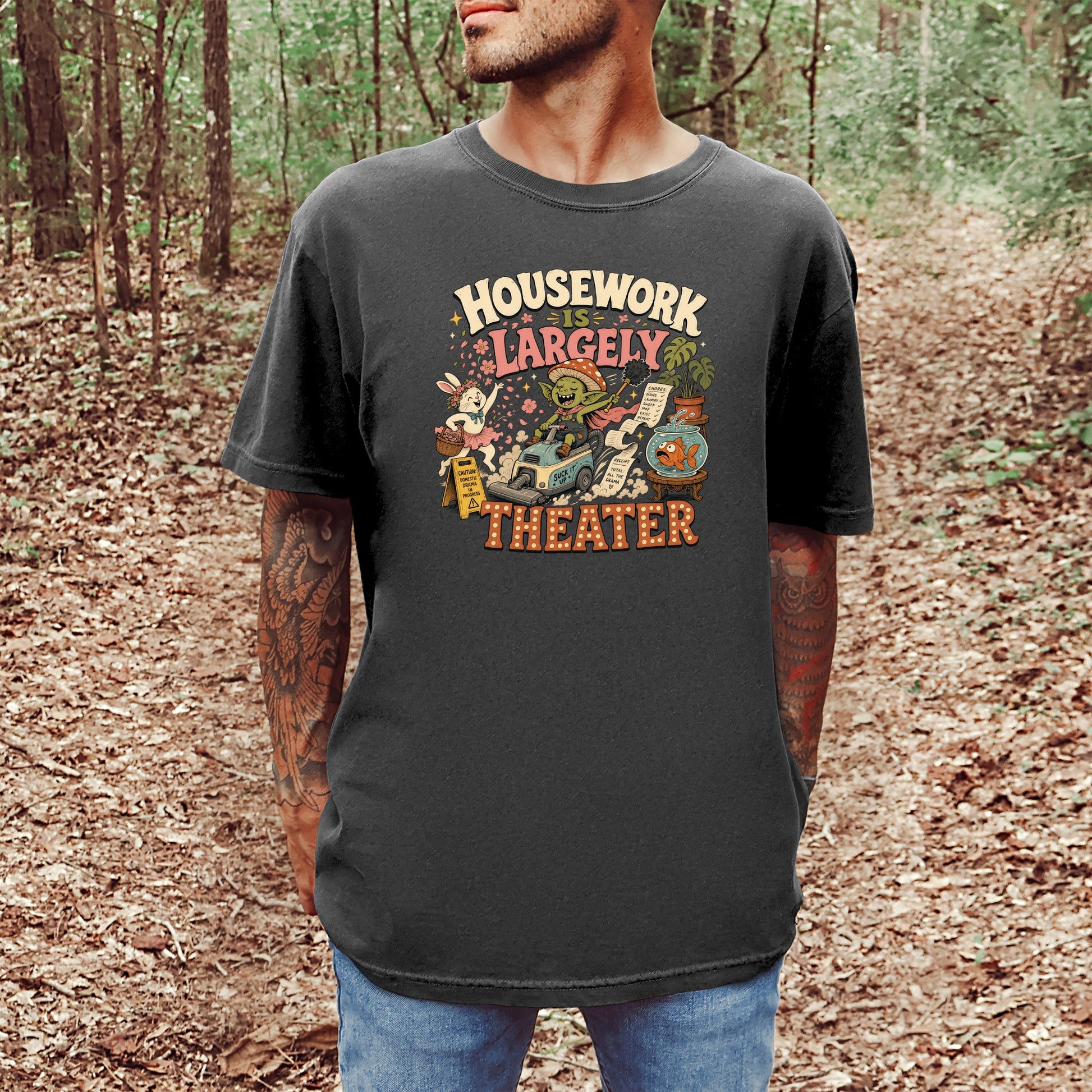 T-shirt graphic with text "HOUSEWORK IS LARGELY THEATER" and cartoon characters.