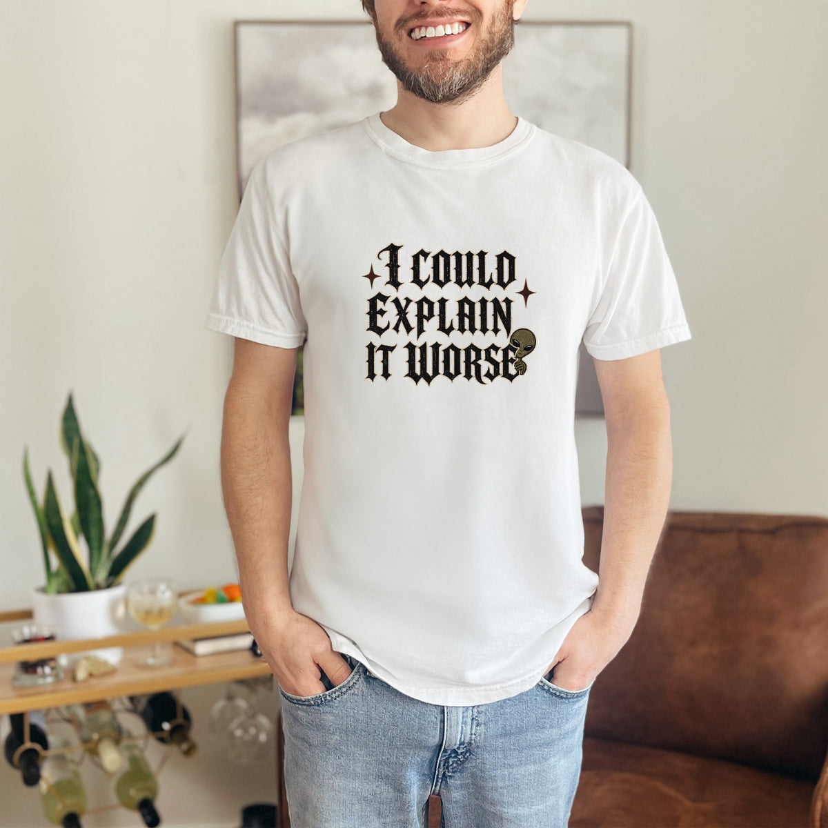 White t-shirt with "I COULD EXPLAIN IT WORSE" text and an alien graphic.