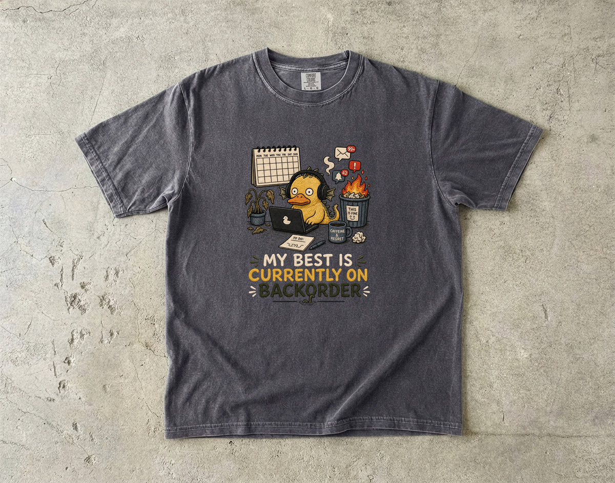 Dark grey t-shirt with cartoon of duck at computer and text "My Best Is Currently On Backorder".