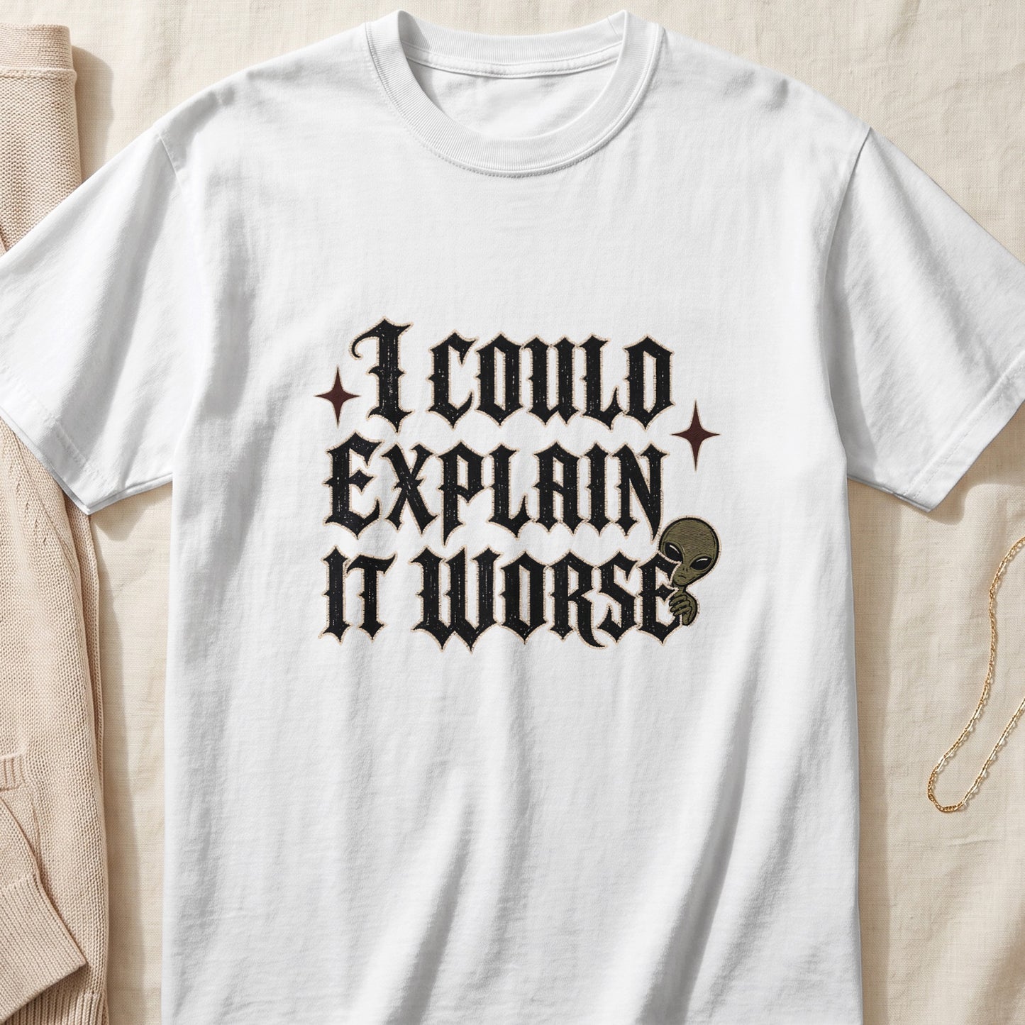 White t-shirt with black gothic text "I COULD EXPLAIN IT WORSE" and an alien graphic.
