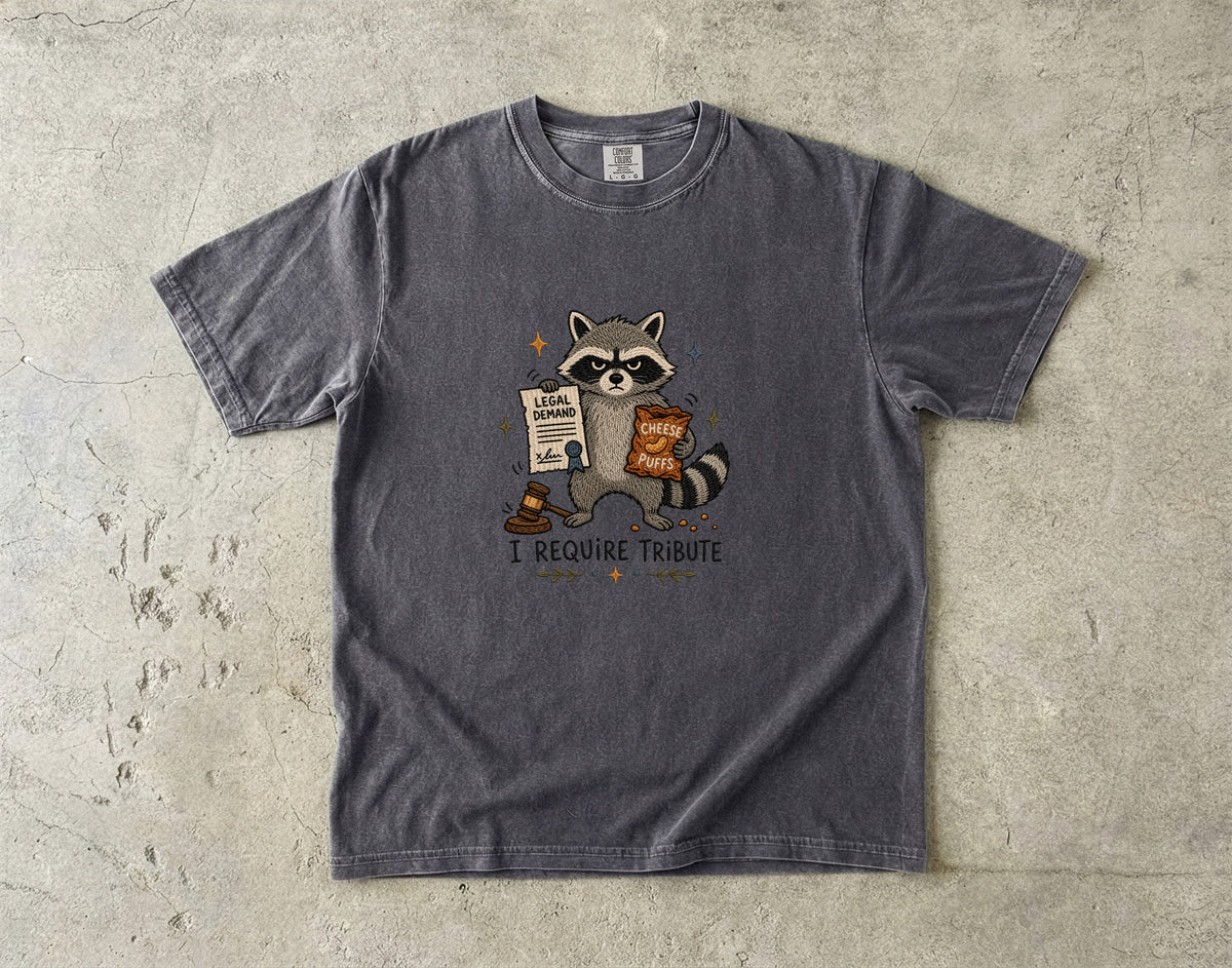 T-shirt with a raccoon holding cheese puffs and a legal demand paper.