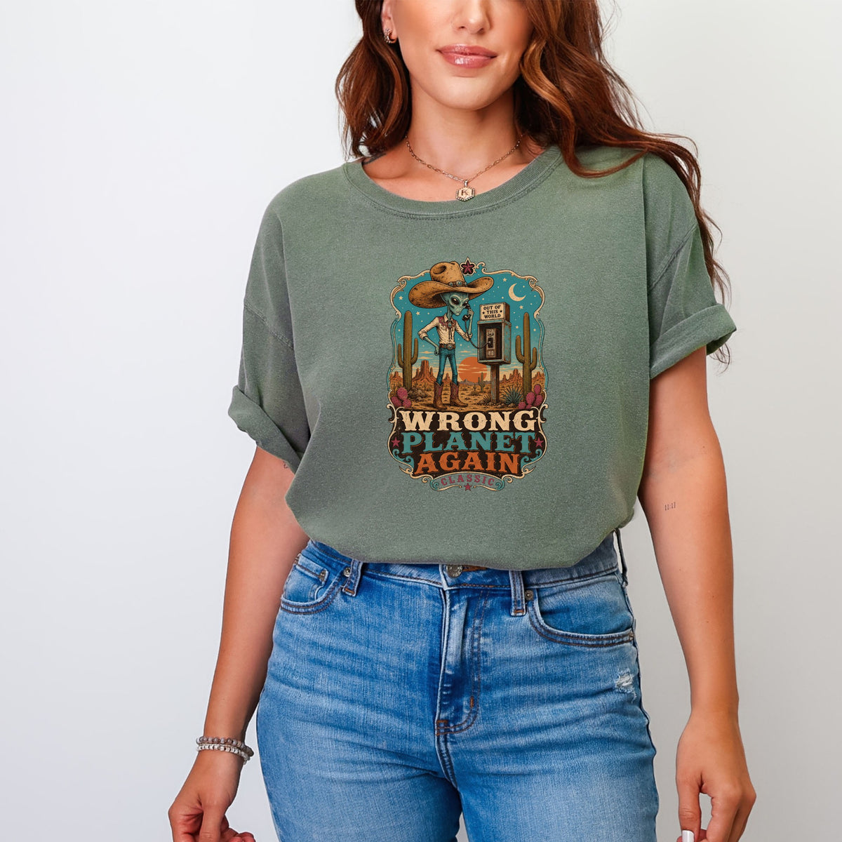 Green t-shirt with desert graphic and text "WRONG PLANET AGAIN CLASSIC".