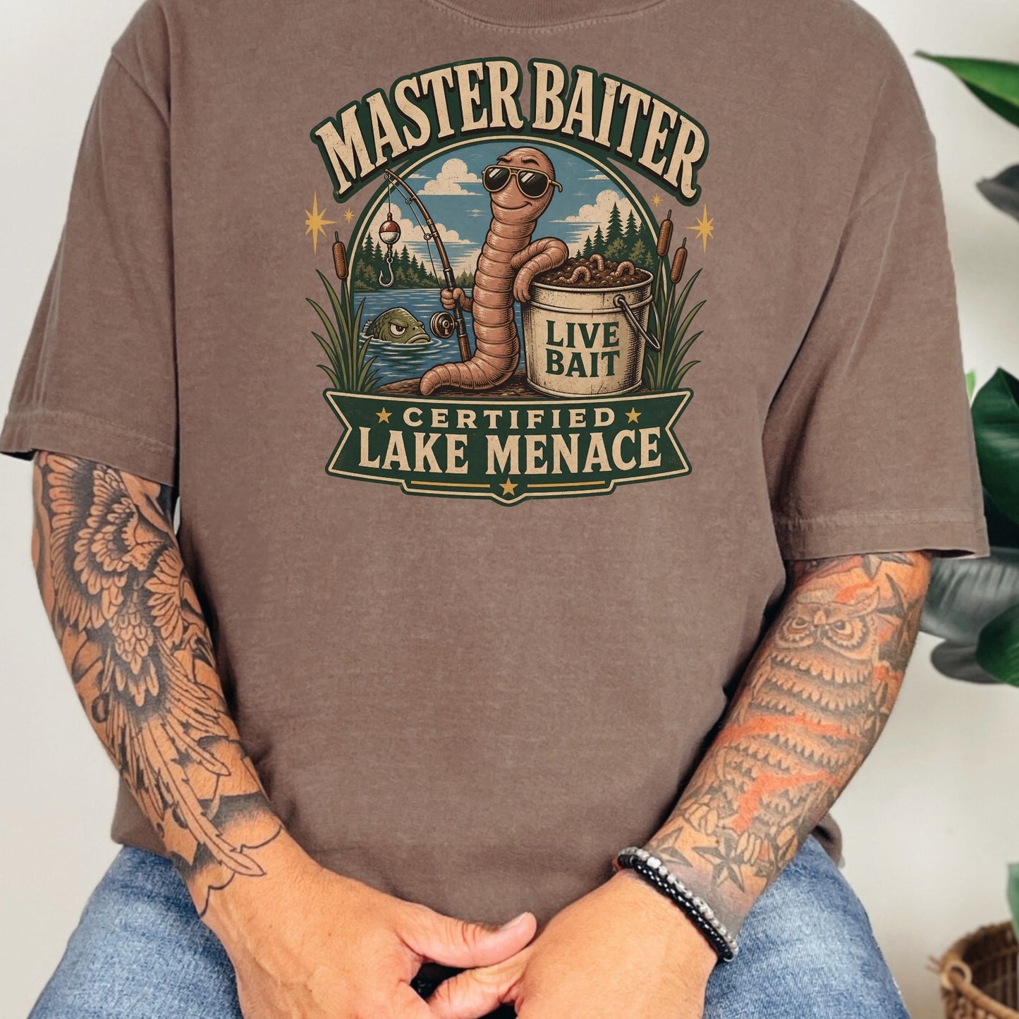 Graphic with text "Master Baiter Certified Lake Menace" featuring a cartoon worm fishing.