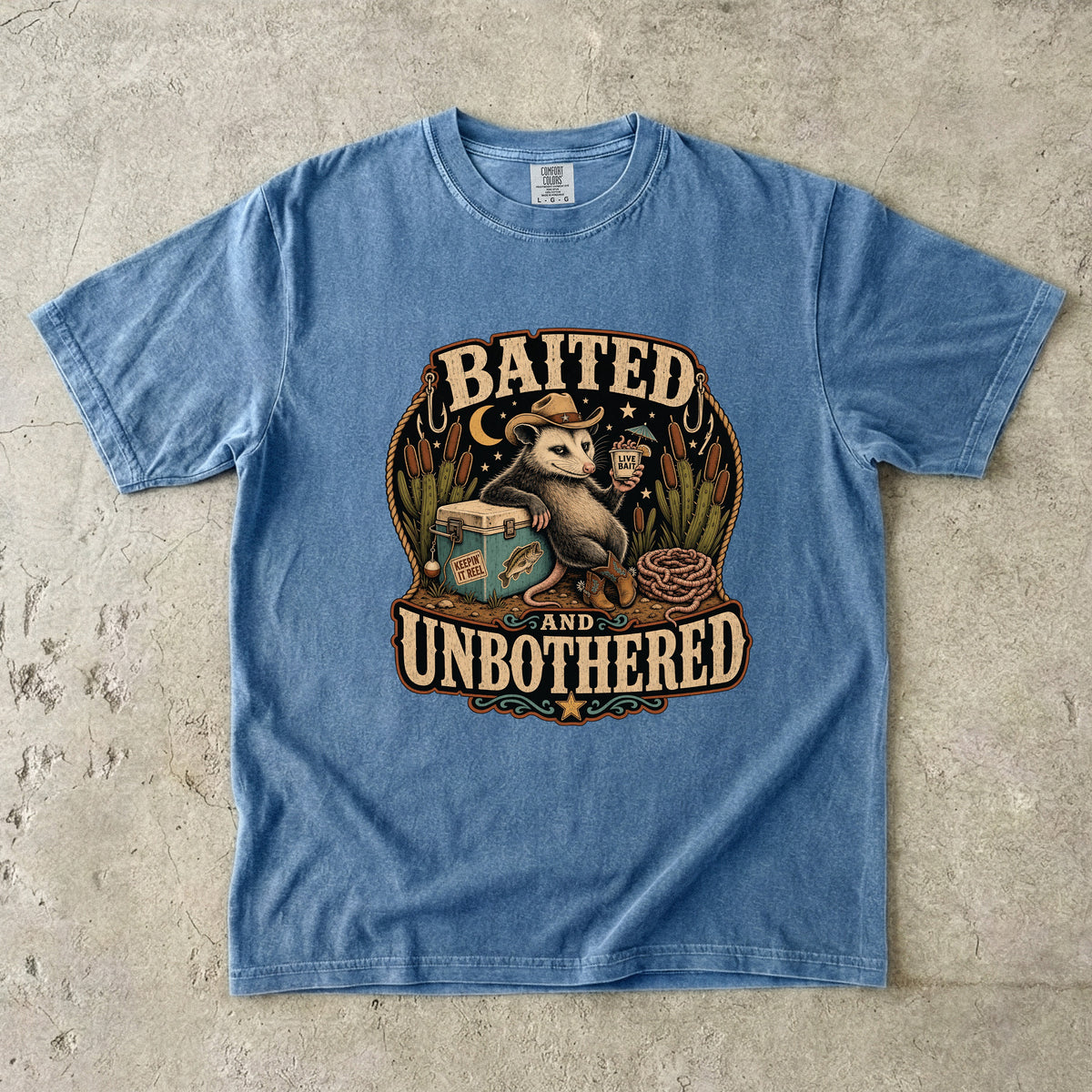 Opossum in cowboy hat with drink and fishing gear, text "BAITED AND UNBOTHERED".