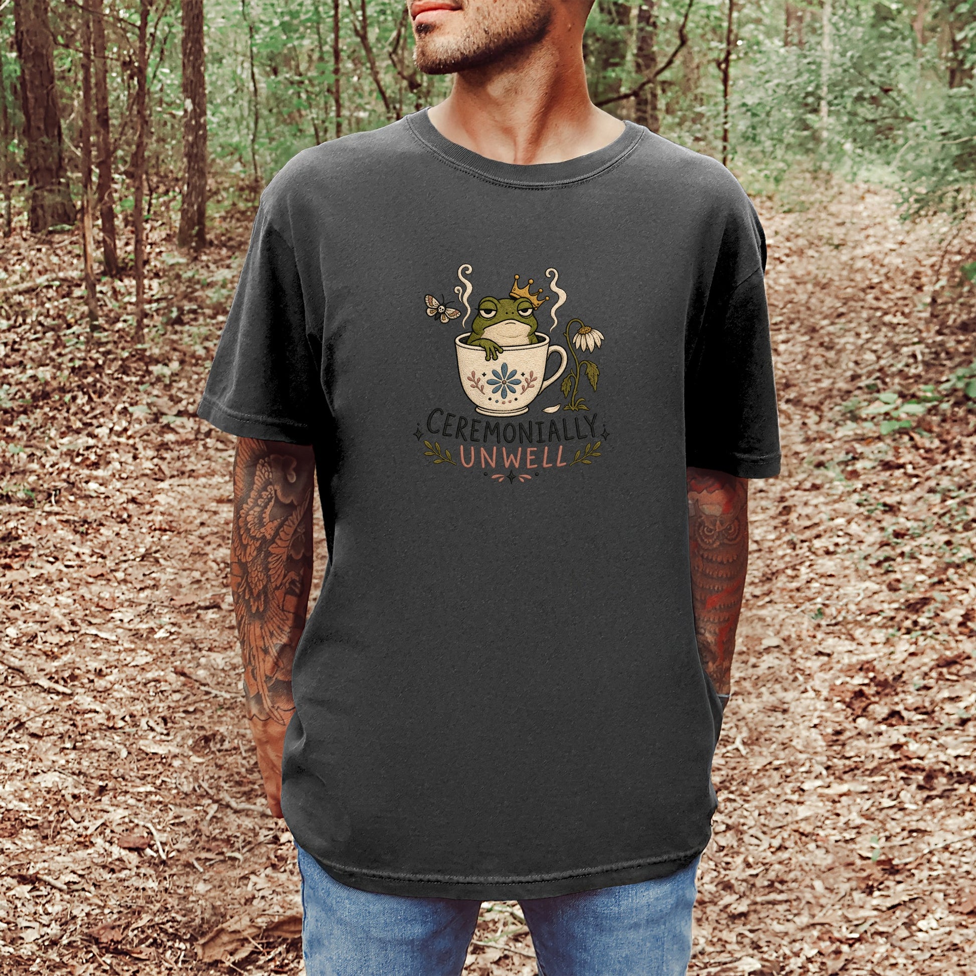 T-shirt graphic of frog in crown in teacup with text "CEREMONALLY UNWELL"